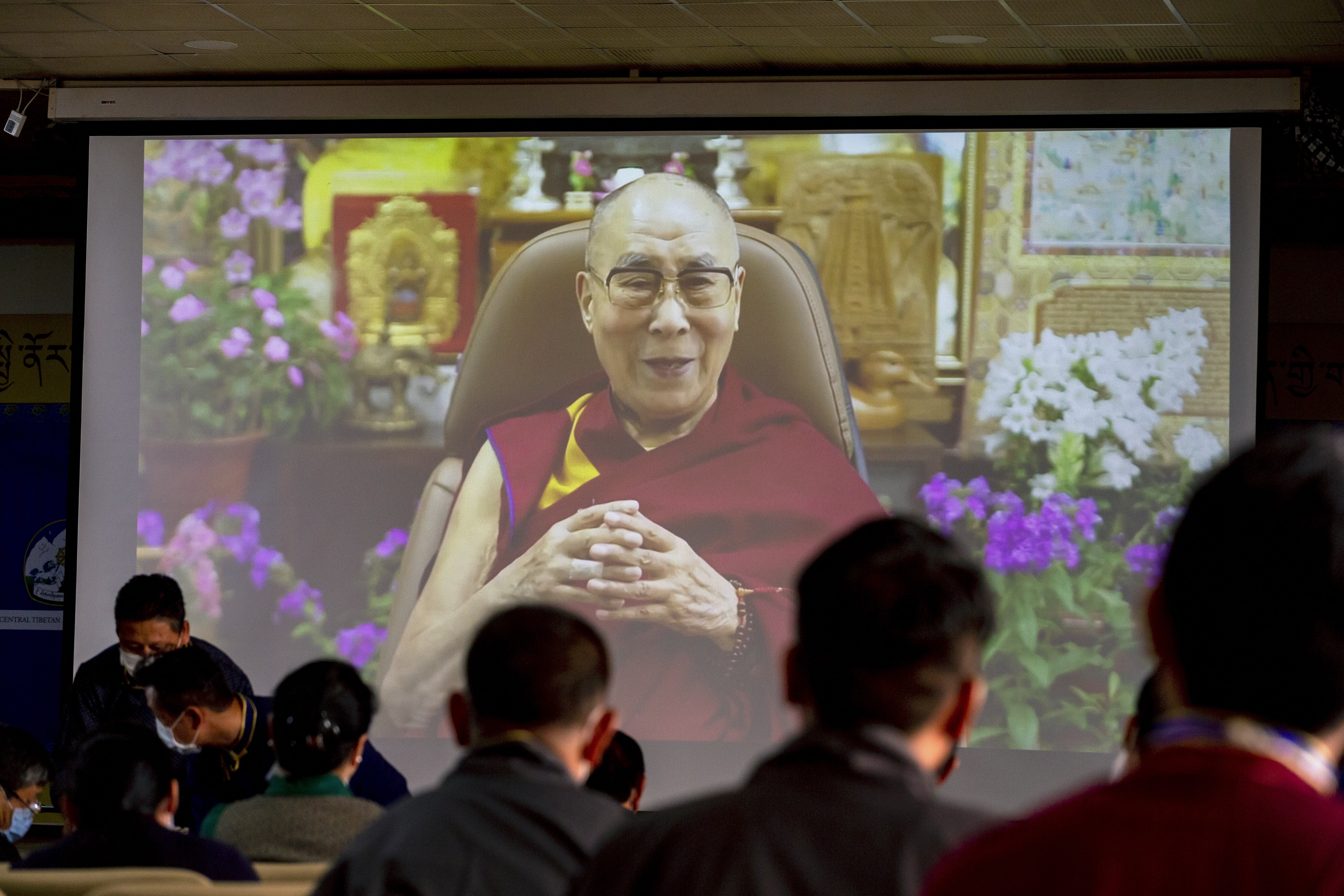 Exiled Tibetan government officials watch a video message from the 14th Dalai Lama in Dharamshala, India, on July 6, 2021. Photo: AP