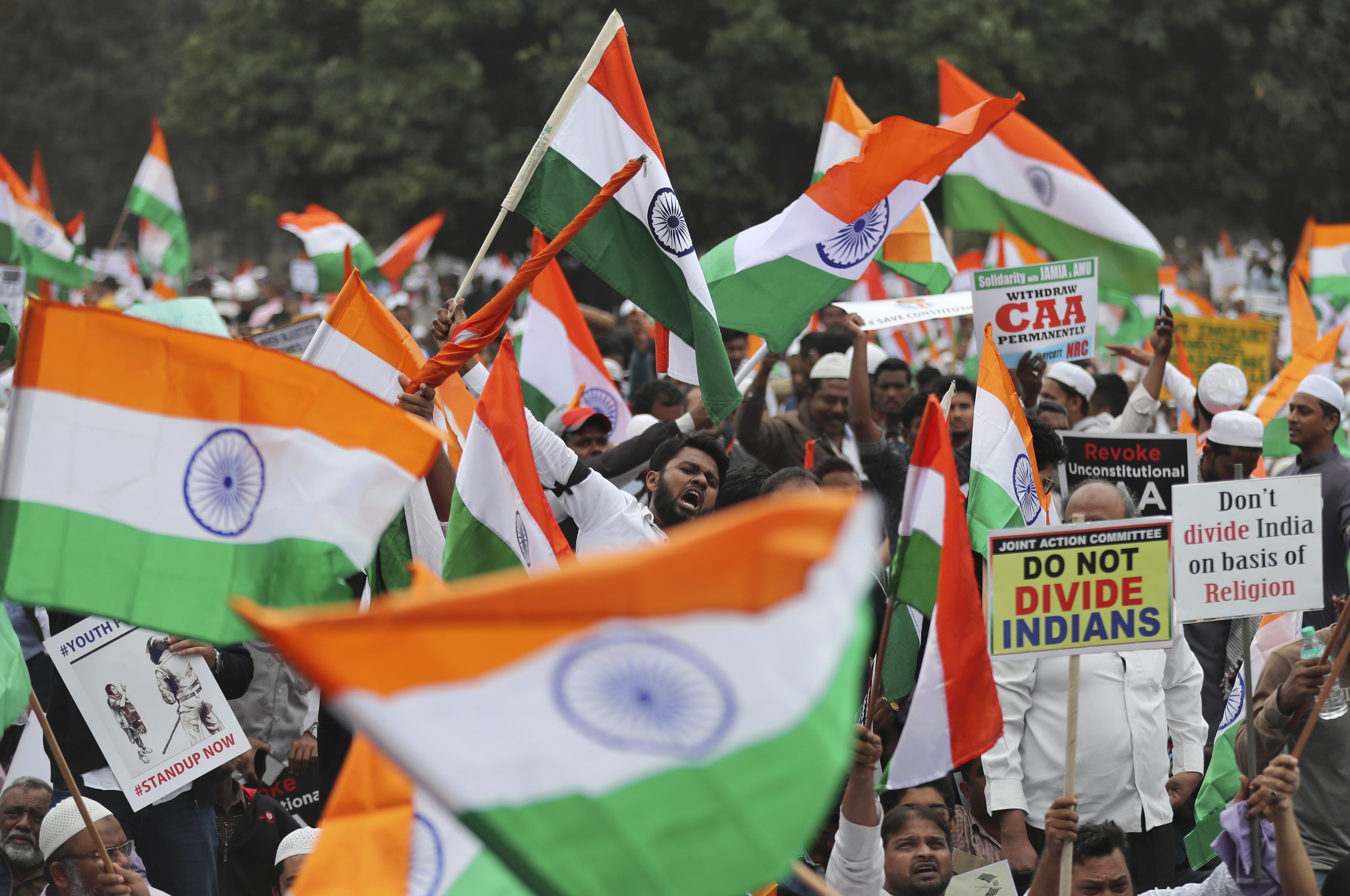 Indians hold national flags and placards during a protest against a 2019 citizenship law introduced by the BJP government that fast-tracked citizenship for refugees of other religions but not Muslims. Photo: AP