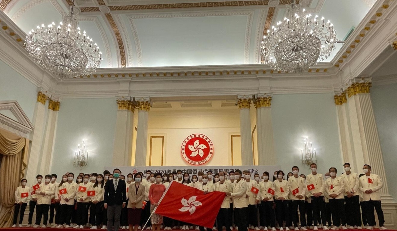 Chief Executive Carrie Lam Cheng Yuet-ngor presents the HKSAR flag to the Hong Kong delegation to the Tokyo Olympic Games. Photo: Hong Kong Olympic Committee
