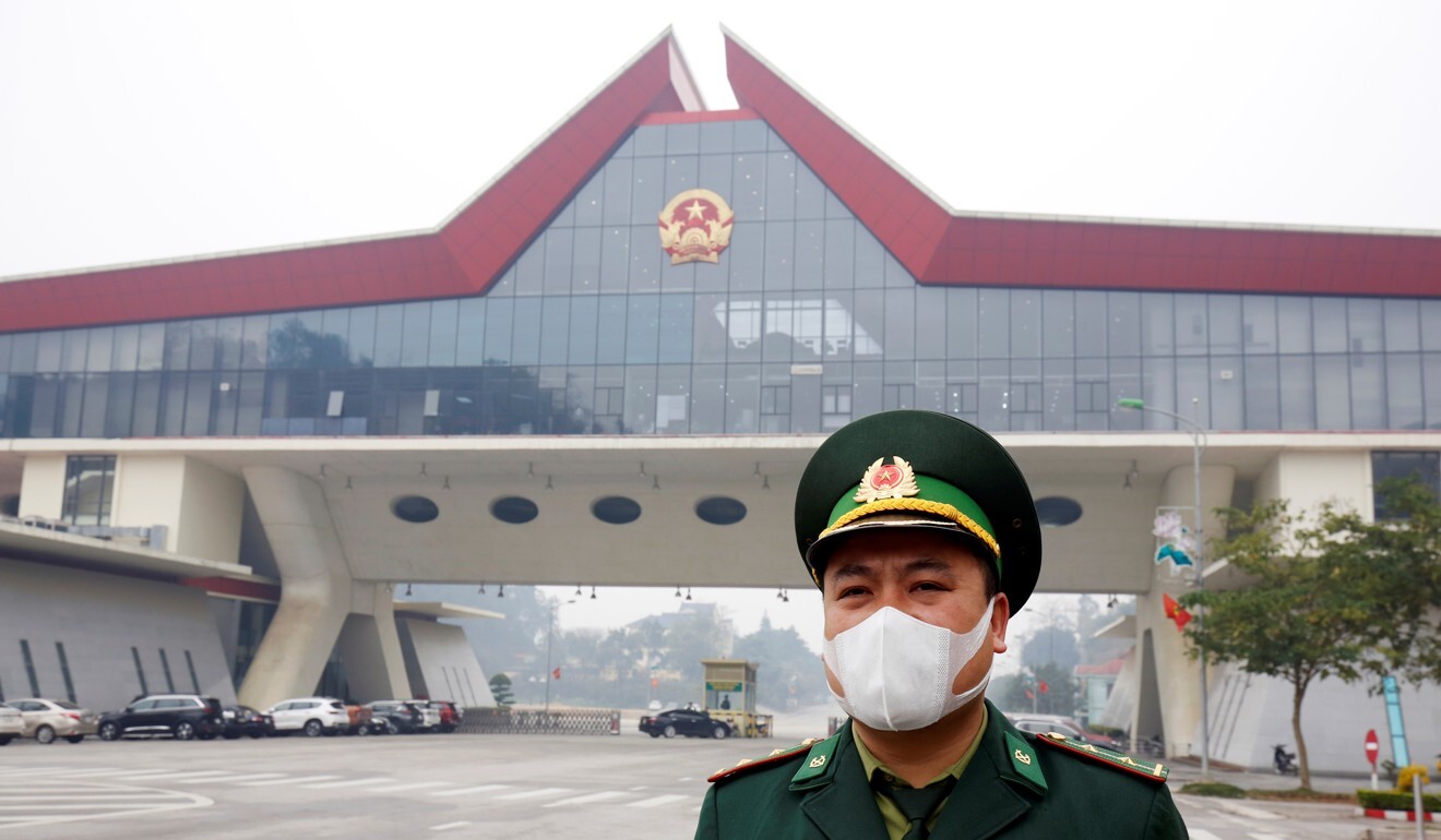 A Vietnamese officer stands guard at a border gate connecting the country to China. Photo: Reuters