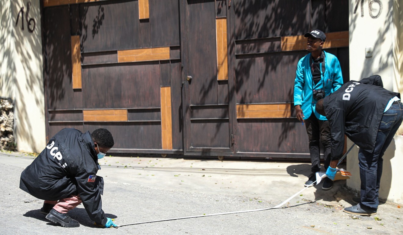 Haitian police and forensics officers look for evidence outside the presidential residence in Port-au-Prince, Haiti. Photo: AFP