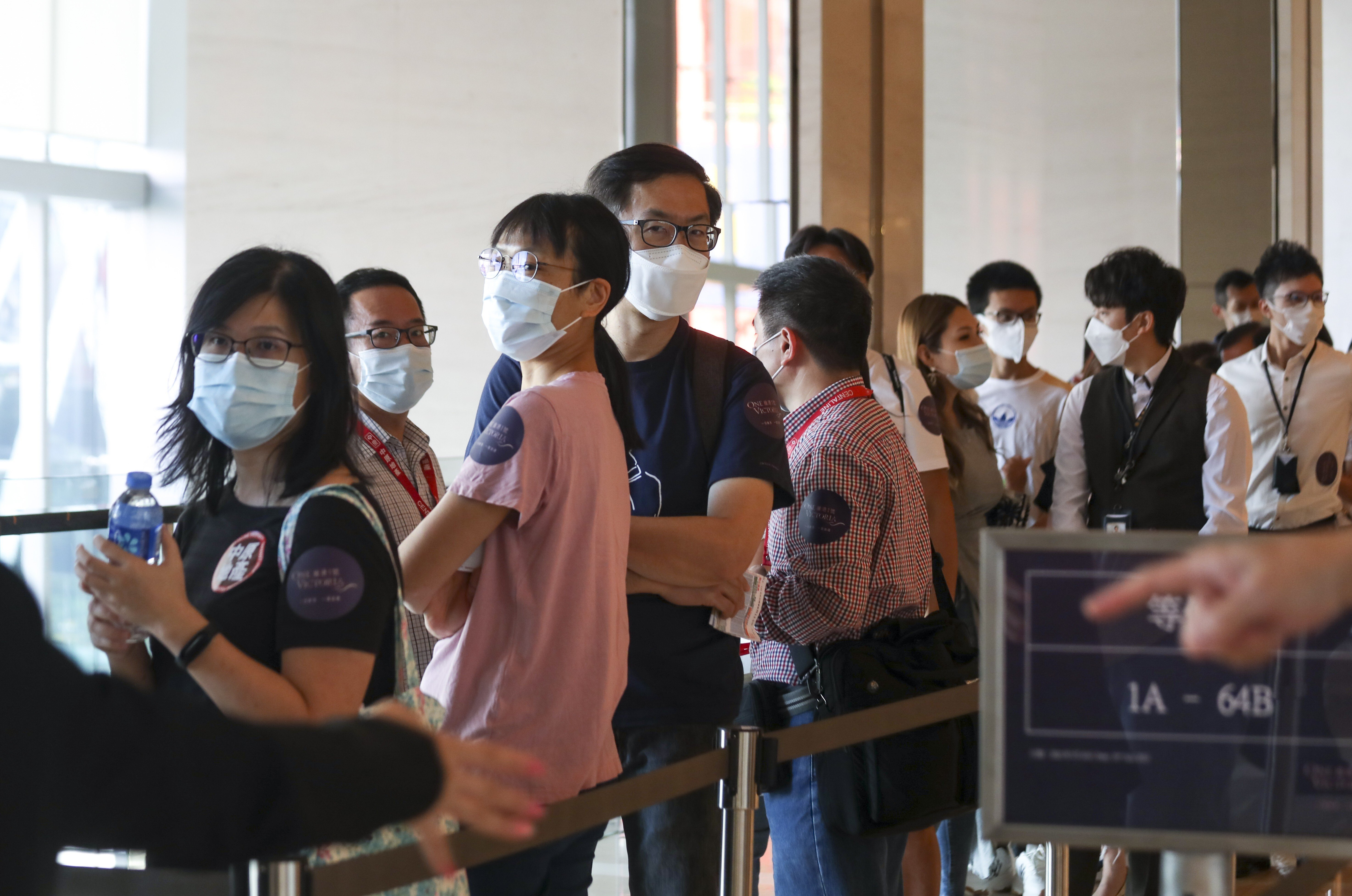 Property buyers queueing up for the One Victoria apartments in Kai Tak at the sales office of China Overseas Land and Investments (COLI) at the Exchange Tower on July 10, 2021. Photo: Xiaomei Chen.