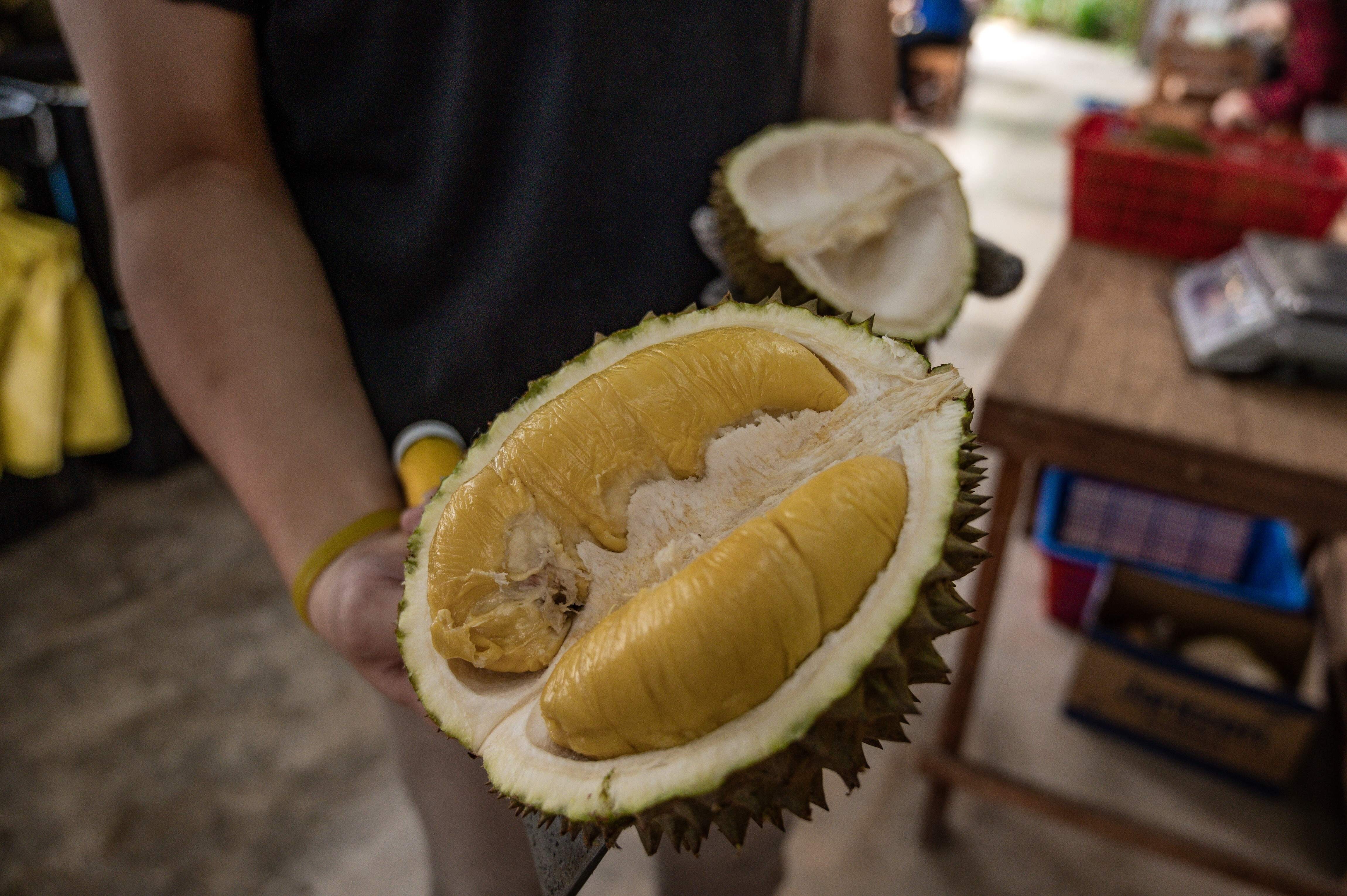 A worker shows a ‘Musang King’ durian at a shop in Kuala Lumpur last year. Photo: AFP