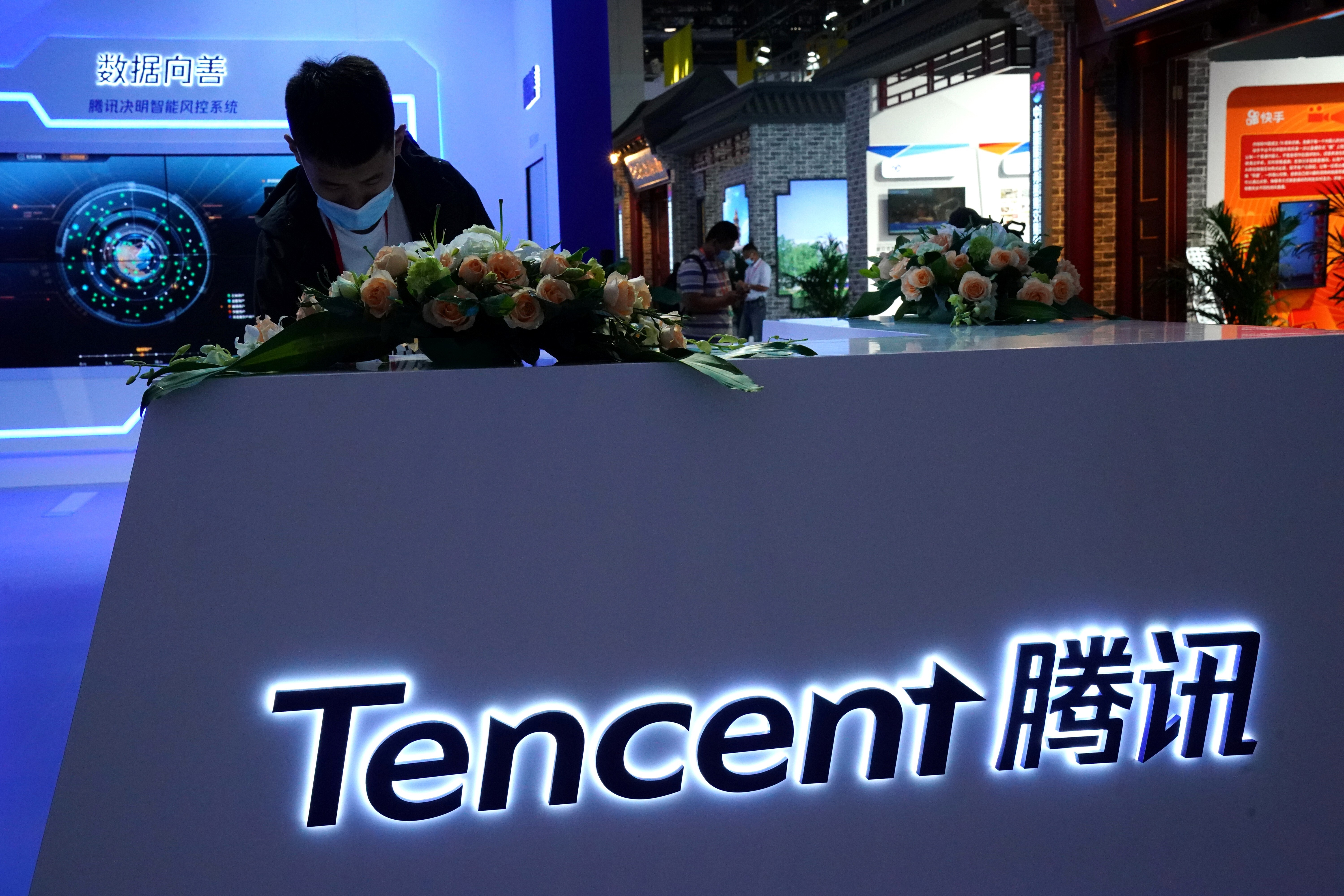 A staff member wearing a face mask following the coronavirus disease (COVID-19) outbreak is seen at a booth Tencent at the 2020 China International Fair for Trade in Services (CIFTIS) in Beijing, China. Photo: Reuters