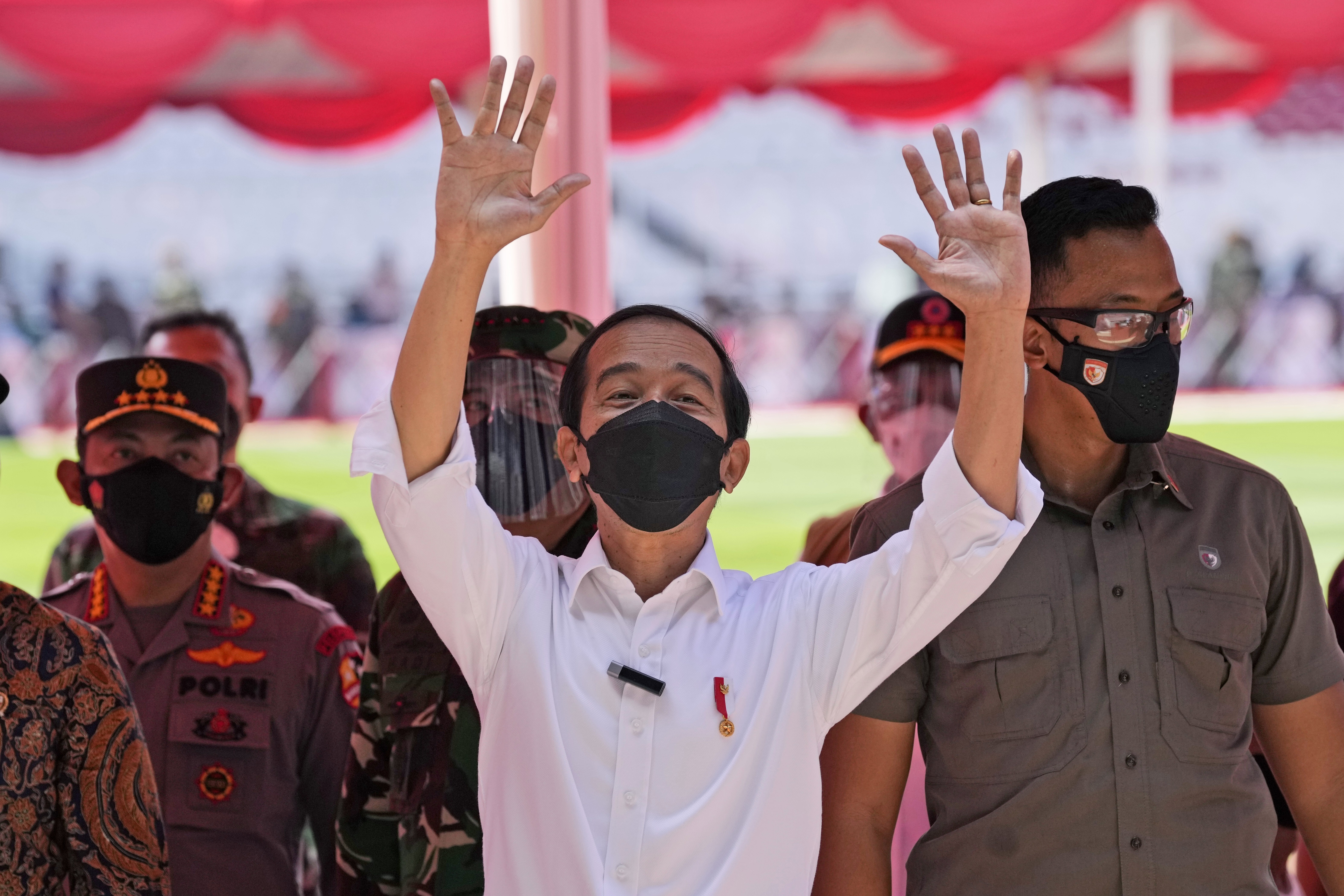 Indonesian President Joko Widodo waves during a visit to a mass vaccination campaign at a stadium in Jakarta last month. Photo: AP
