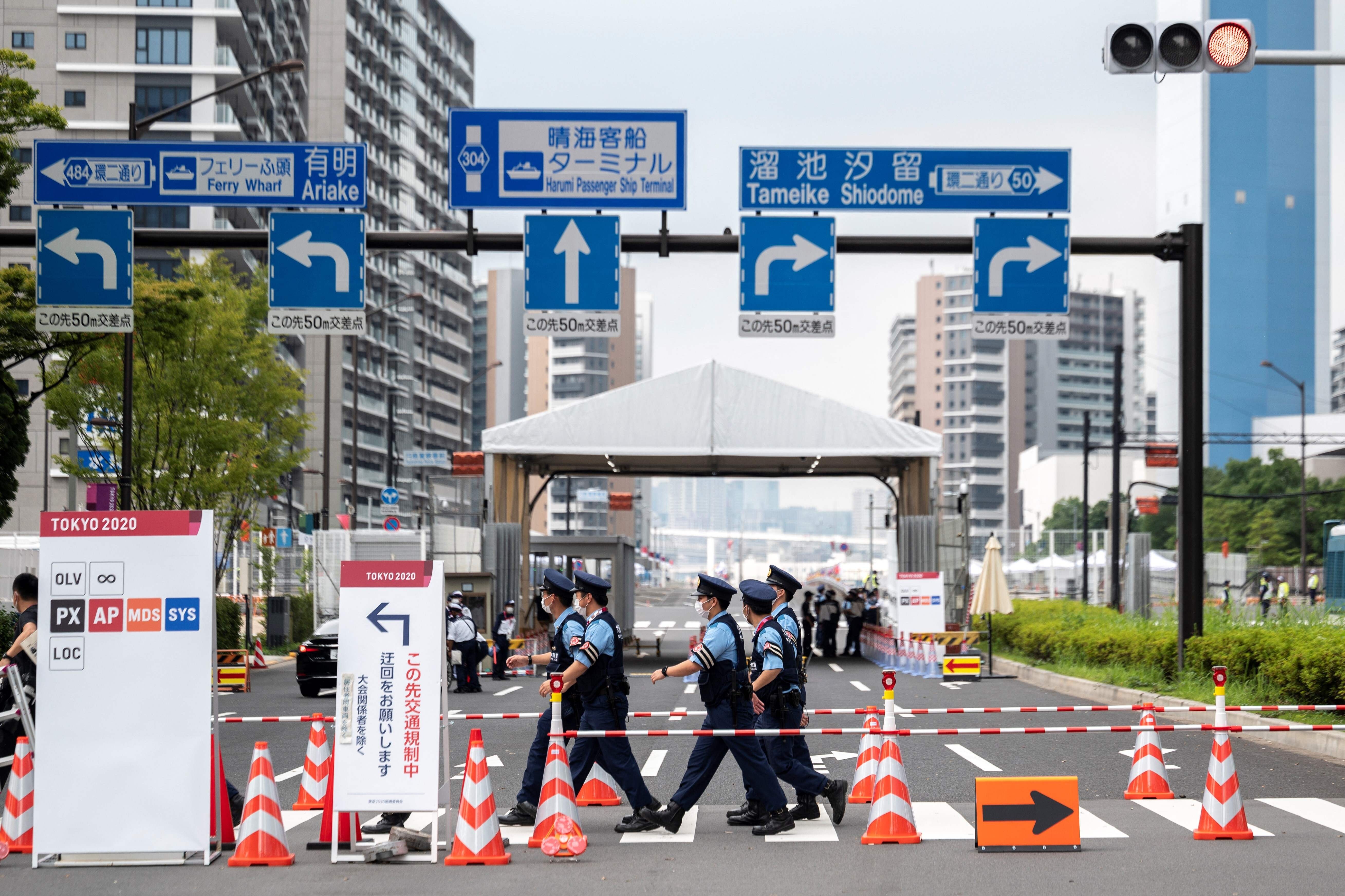 Police officers walk past one of the entrances to the Olympic Village in Tokyo on July 13, ahead of the 2020 Tokyo Olympics which begin on July 23. Photo: AFP