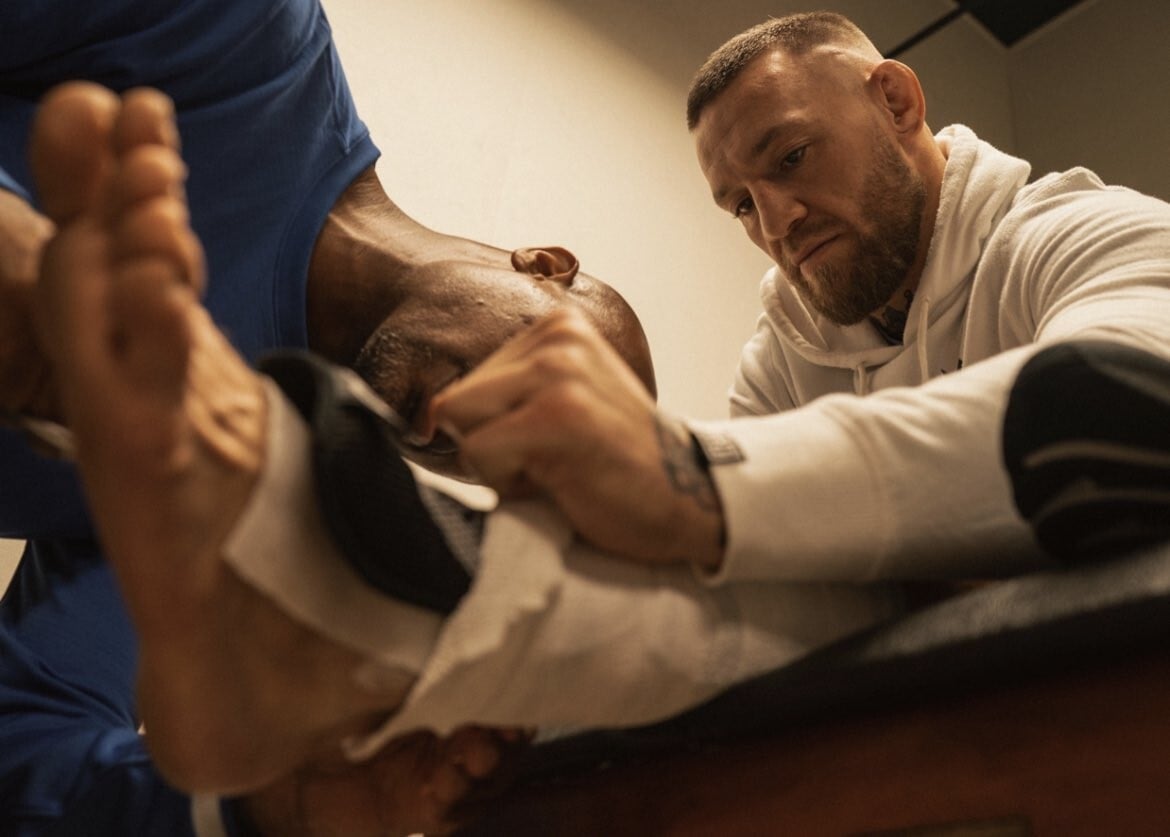 Conor McGregor receives treatment on his heavily-taped left ankle. Photo: Twitter/@TheNotoriousMMA