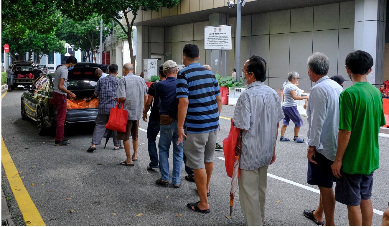 People stand in line to receive food donations in Kuala Lumpur. Photo: Bloomberg