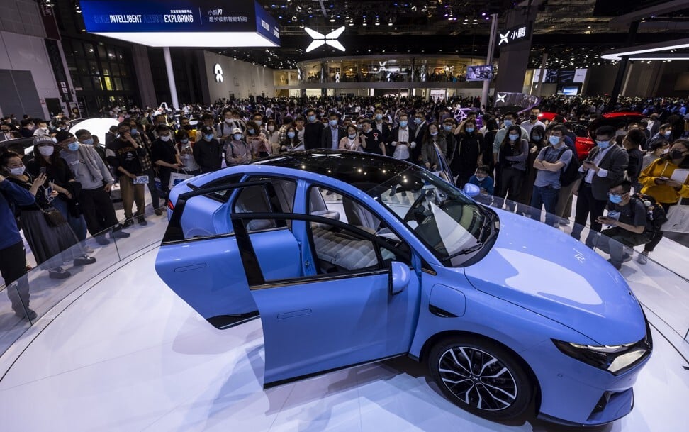 People looking at the P5 car on display at the Xpeng stand during the Auto Shanghai 2021 show in April. Photo: EPA-EFE