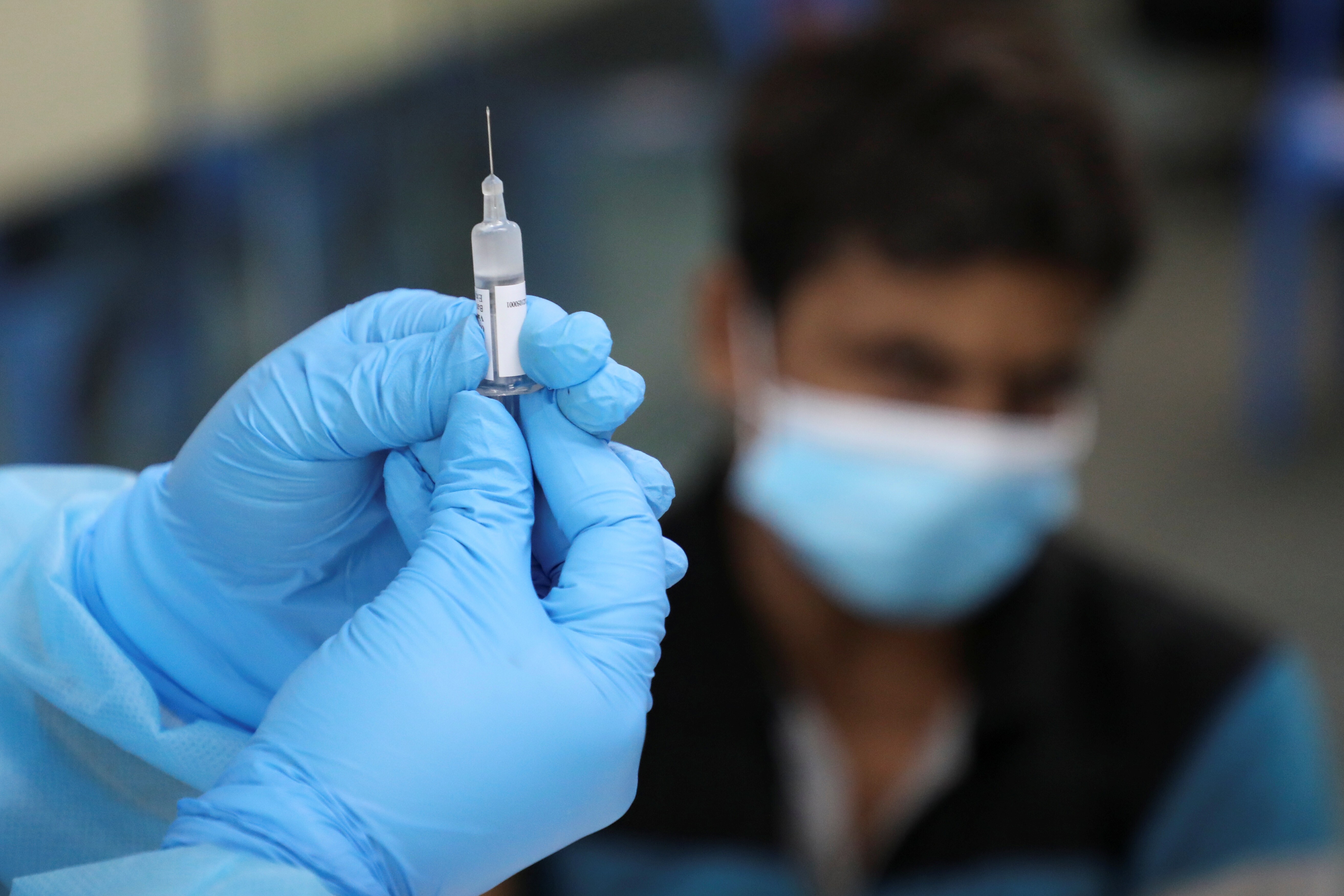 A medical worker prepares a coronavirus vaccine shot. More than 14 million doses have been administered in Malaysia since February, with 14 per cent of the population now fully vaccinated. Photo: Reuters