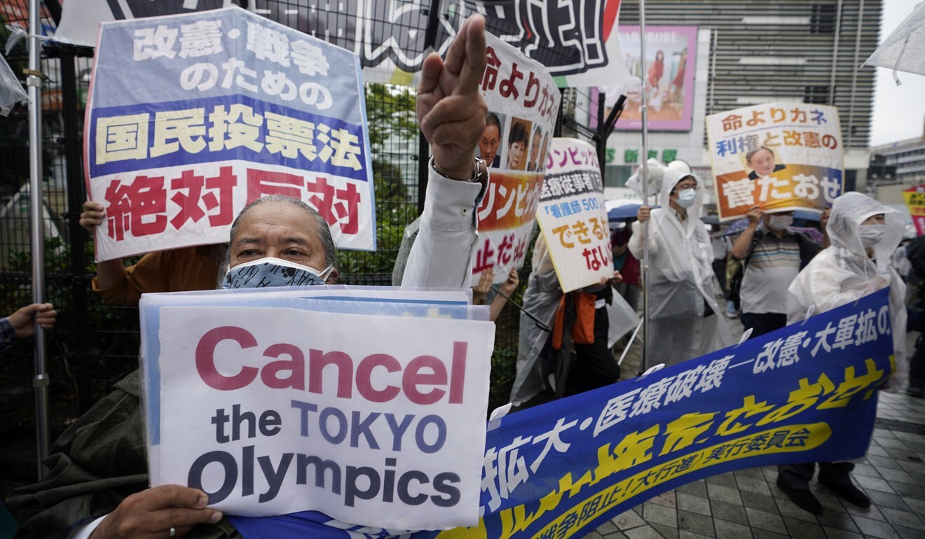 Protesters in Tokyo shout slogans during a June rally against the upcoming Olympic Games. Photo: EPA