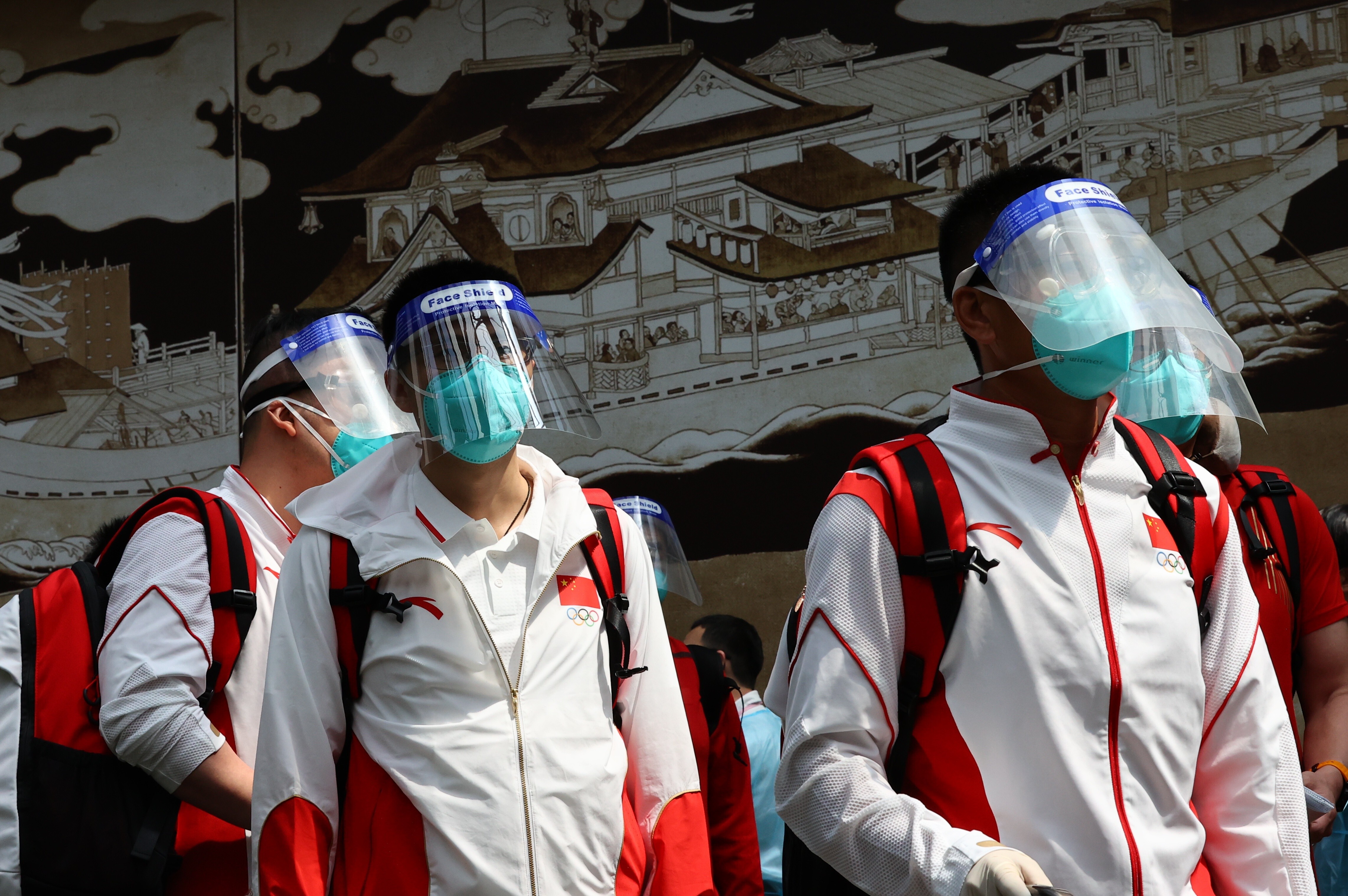 Members of the Chinese team wear protective masks and face shields as they arrive at Narita International Airport ahead of the Tokyo 2020 Olympic Games. Photo: Reuters