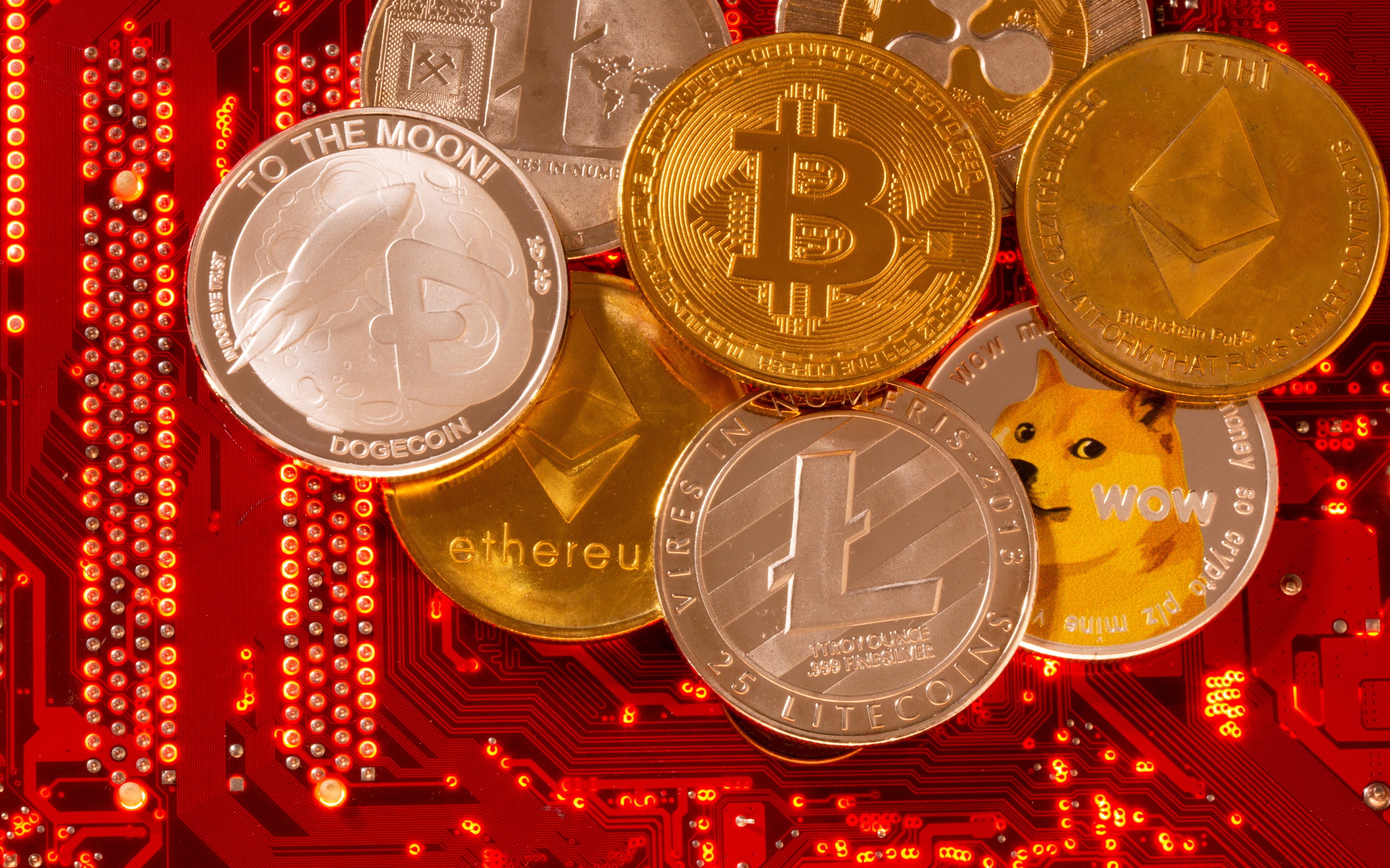 Representations of cryptocurrencies Bitcoin, Ethereum, DogeCoin, Ripple, Litecoin are seen on a PC motherboard. Photo: Reuters