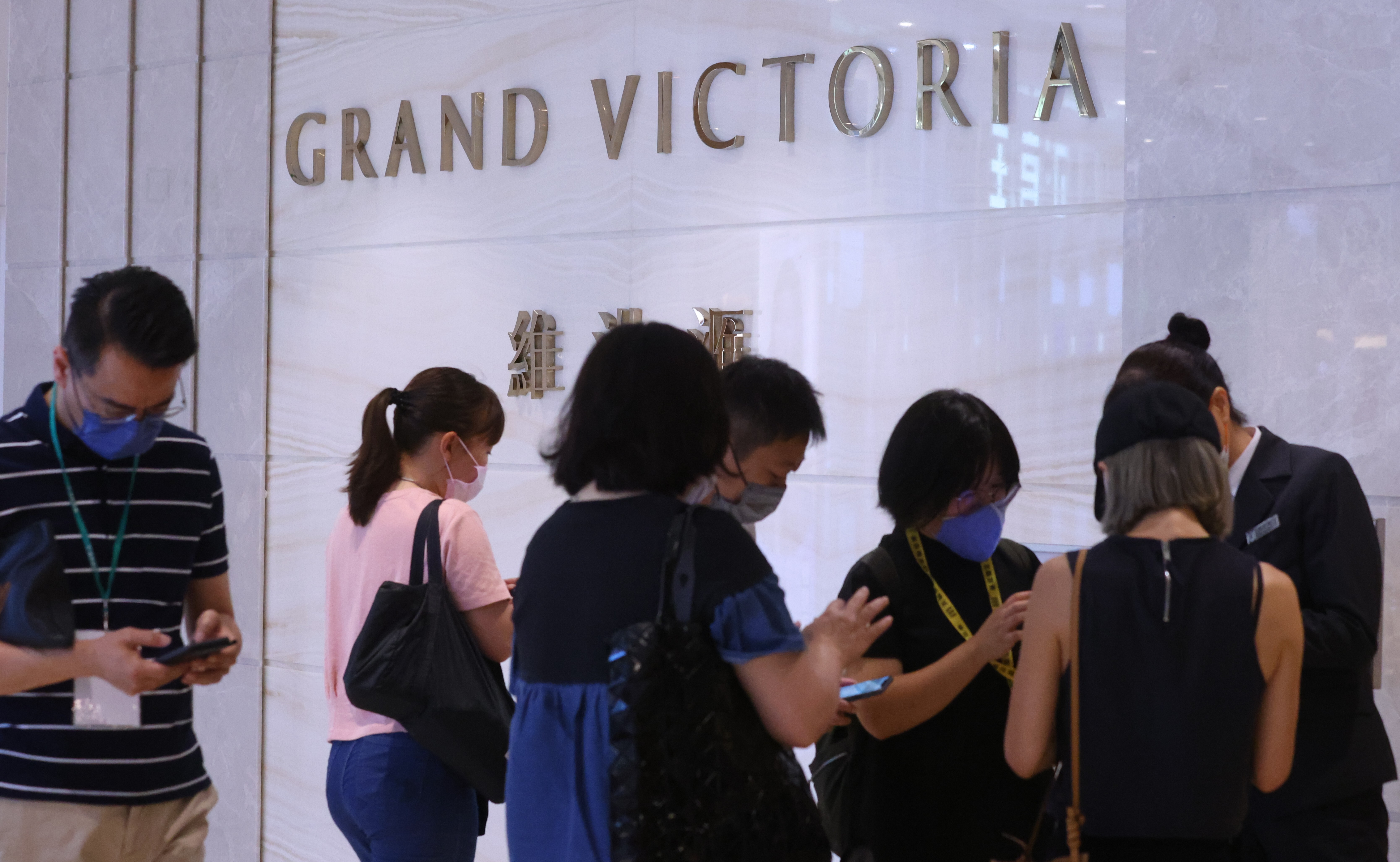 Buyers queuing to bid for 143 units of Grand Victoria flats at the developer’s sales office in Olympian City 2 on July 11, 2021. Photo: Dickson Lee