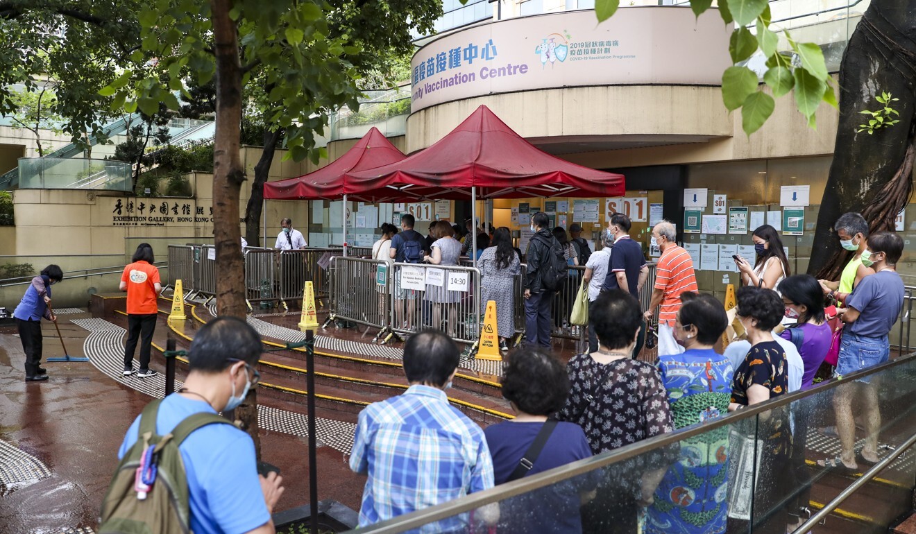 People queue for Sinovac jabs at the Hong Kong Central Library in Causeway Bay. Photo: Winson Wong