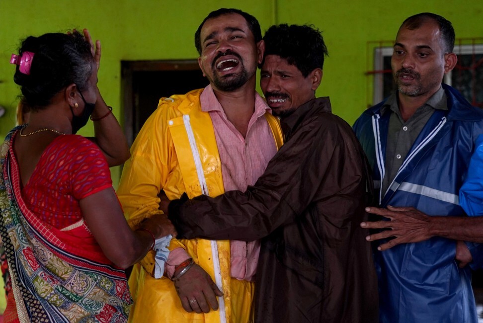 Vijay Pande is consoled by relatives after the dead body of his baby boy was recovered at the site of a landslide in Mahad, Raigad district in Maharashtra, India on Saturday. Photo: Reuters