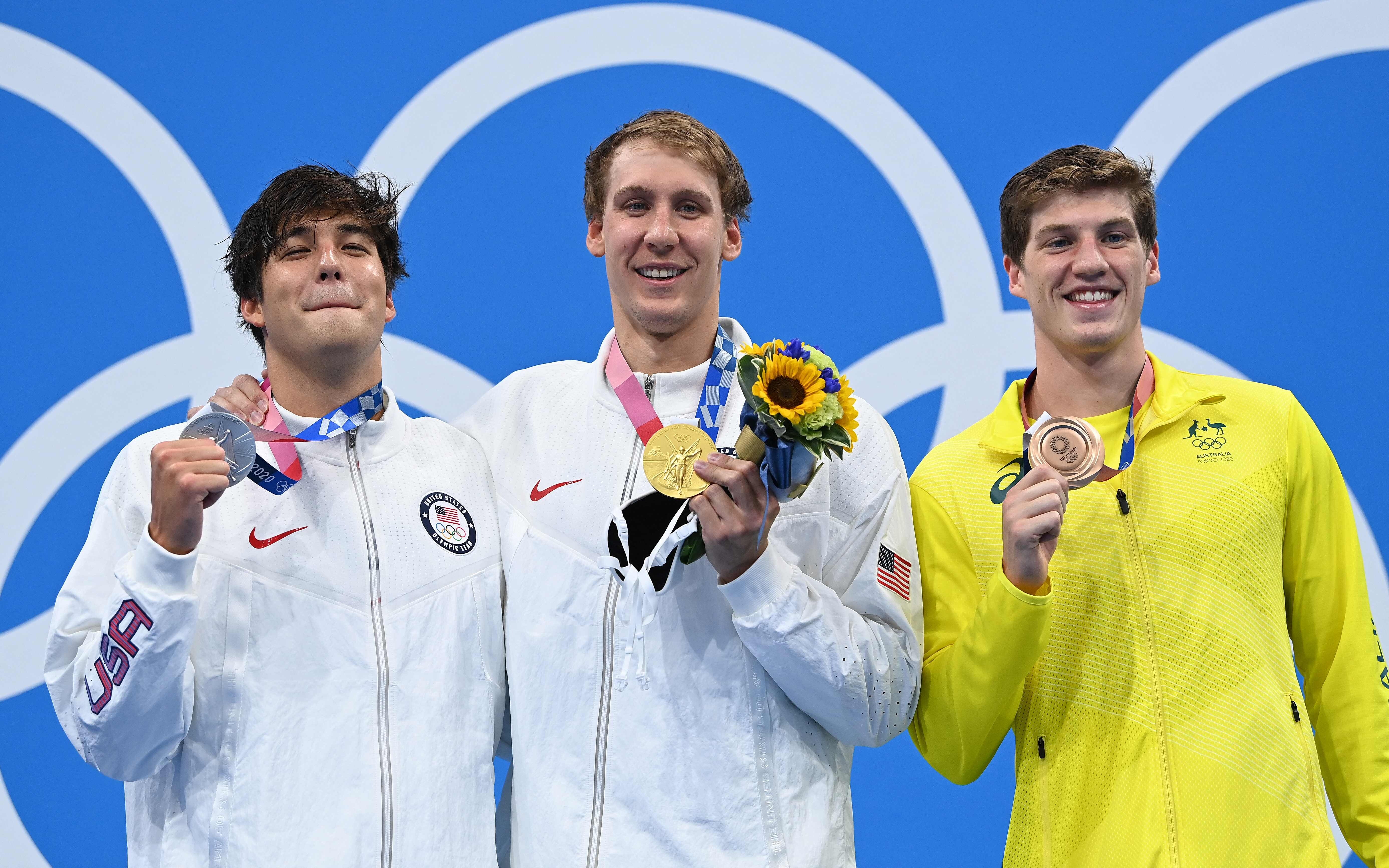 Silver medallist Jay Litherland, gold medallist Chase Kalisz (both from the US) and bronze medallist Brendon Smith from Australia pose maskless with their medals after the final of the men's 400m individual medley swimming event. Photo: AFP