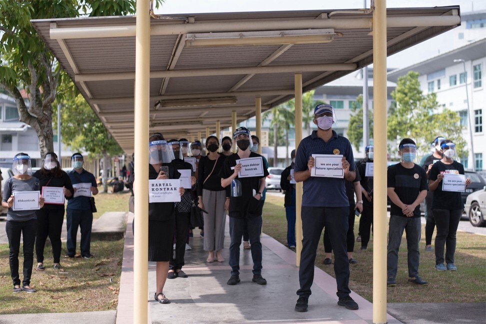 Contract doctors hold placards during a strike outside the Sungai Buloh Hospital in Selangor. Photo: AFP