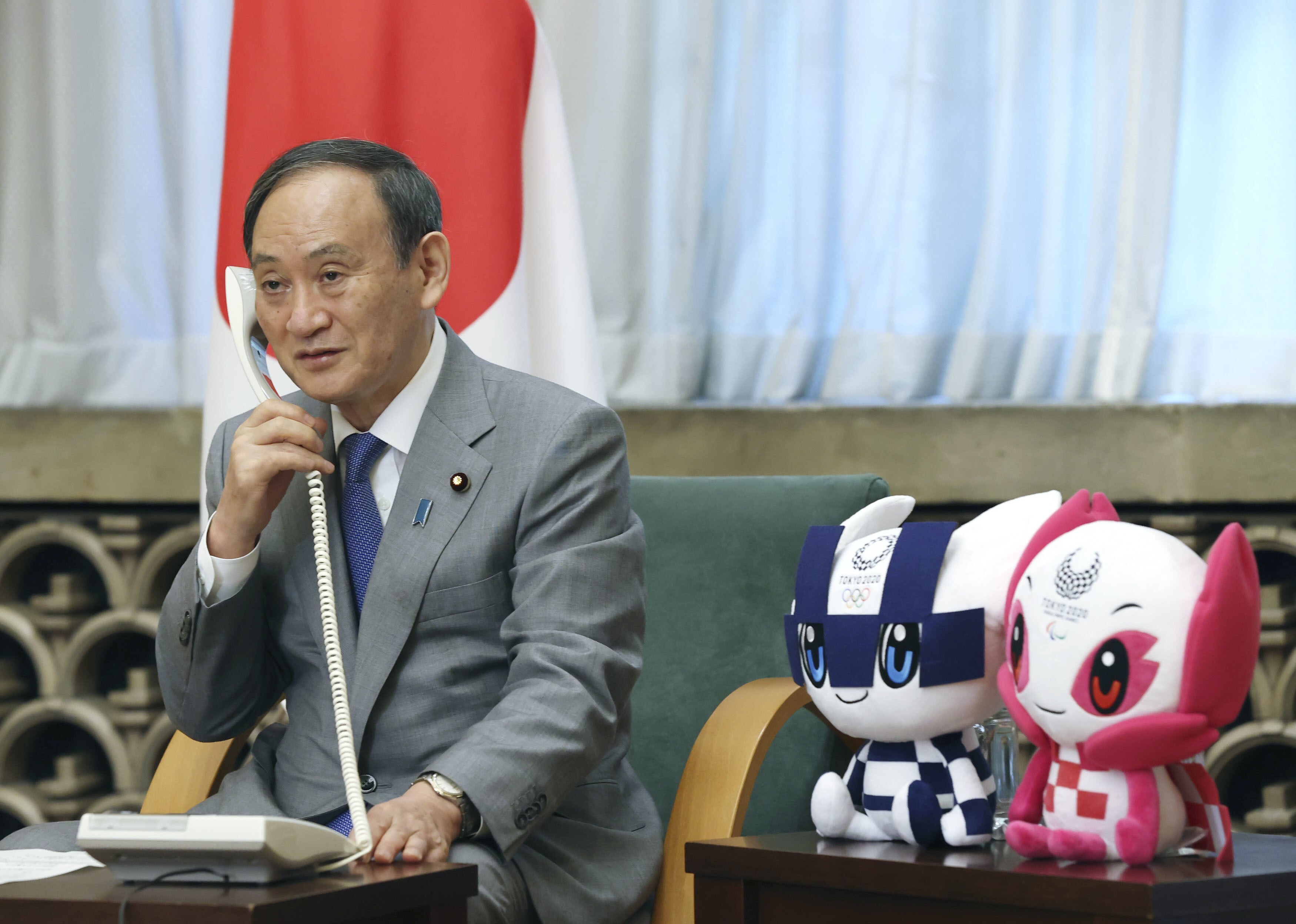 Japanese Prime Minister Yoshihide Suga speaks on the phone with judo gold medallist Naohisa Takato on Sunday. Suga’s approval rating is at the lowest point since he took office last September. Photo: Kyodo