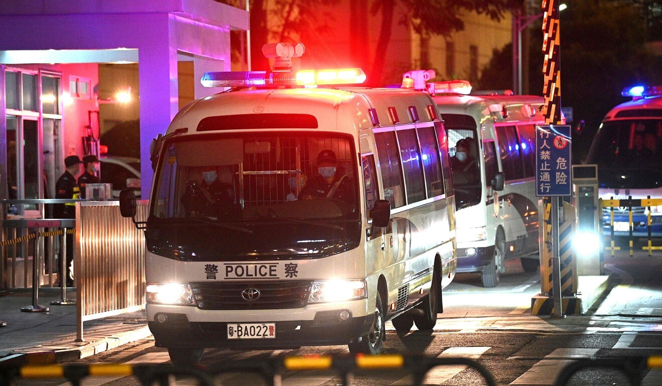 Police vehicles carrying Hoang and 11 other Hong Kong fugitives exit a Shenzhen court in December after a hearing on their cases. Photo: AFP