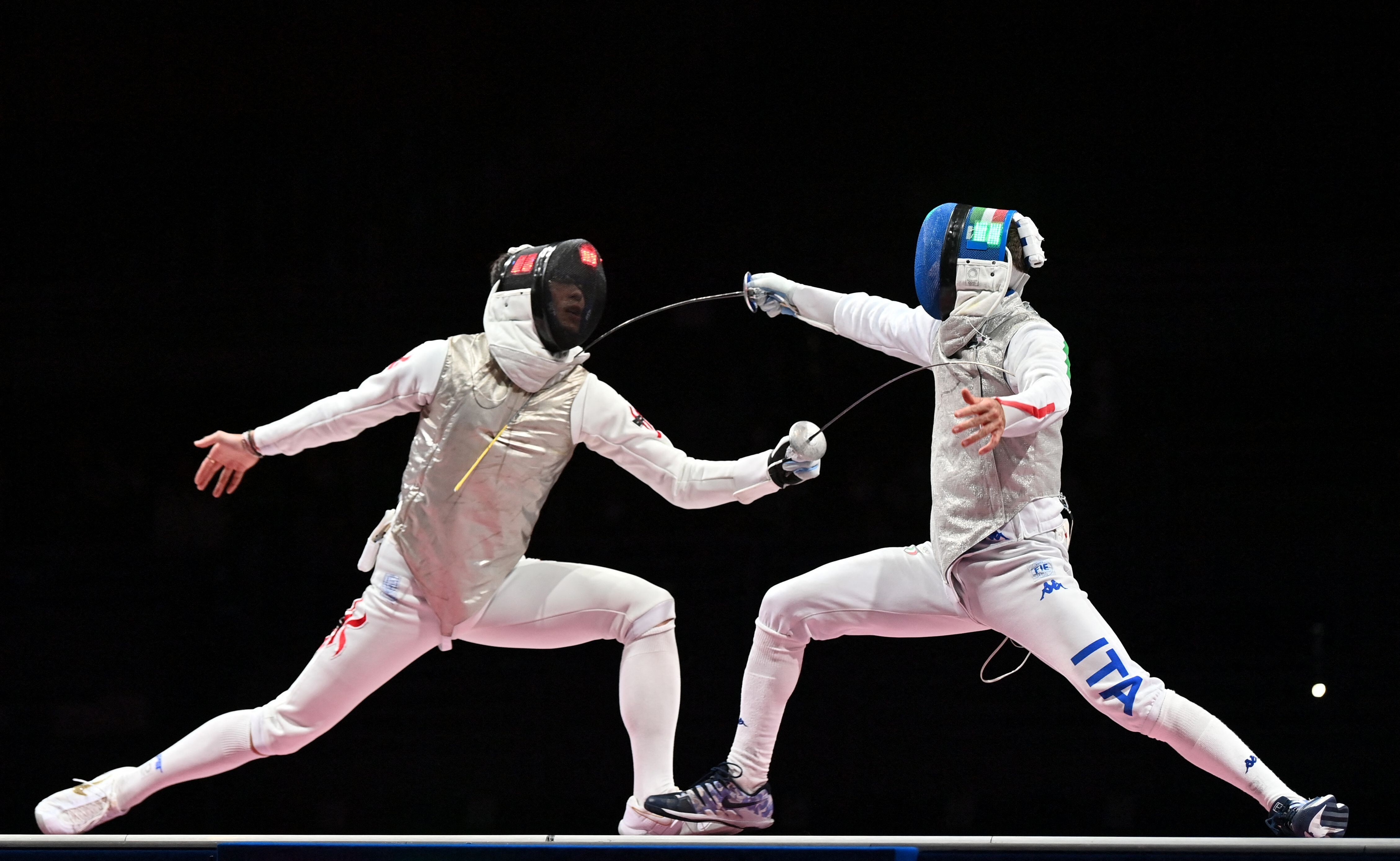 Hong Kong's Edgar Cheung Ka-long (L) competes against Italy's Daniele Garozzo in the men's individual foil gold medal bout during the Tokyo 2020 Olympic Games. Photo: AFP