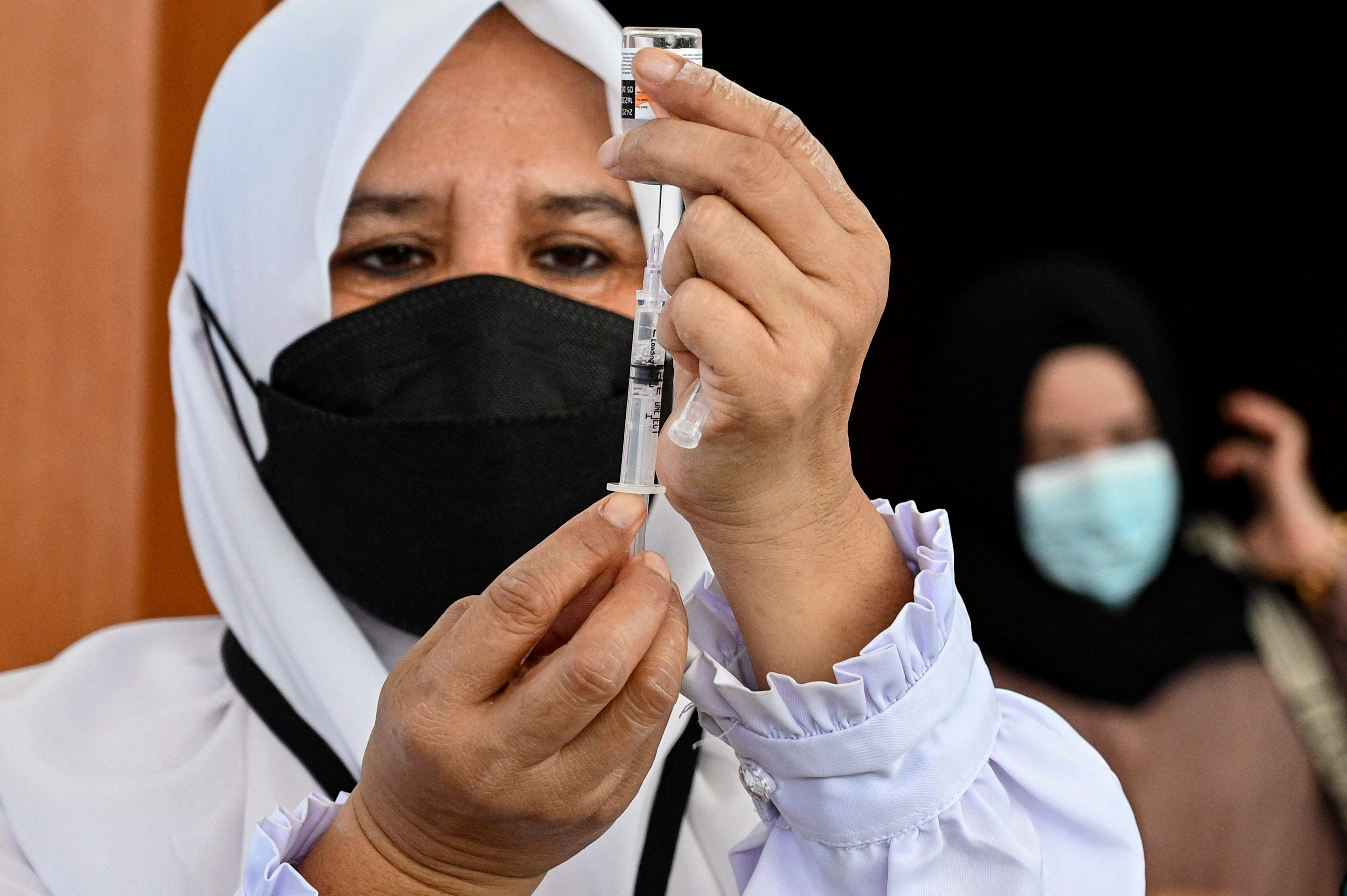 An Indonesian health worker prepares a dose of Covid-19 vaccine in Banda Aceh. Photo: AFP