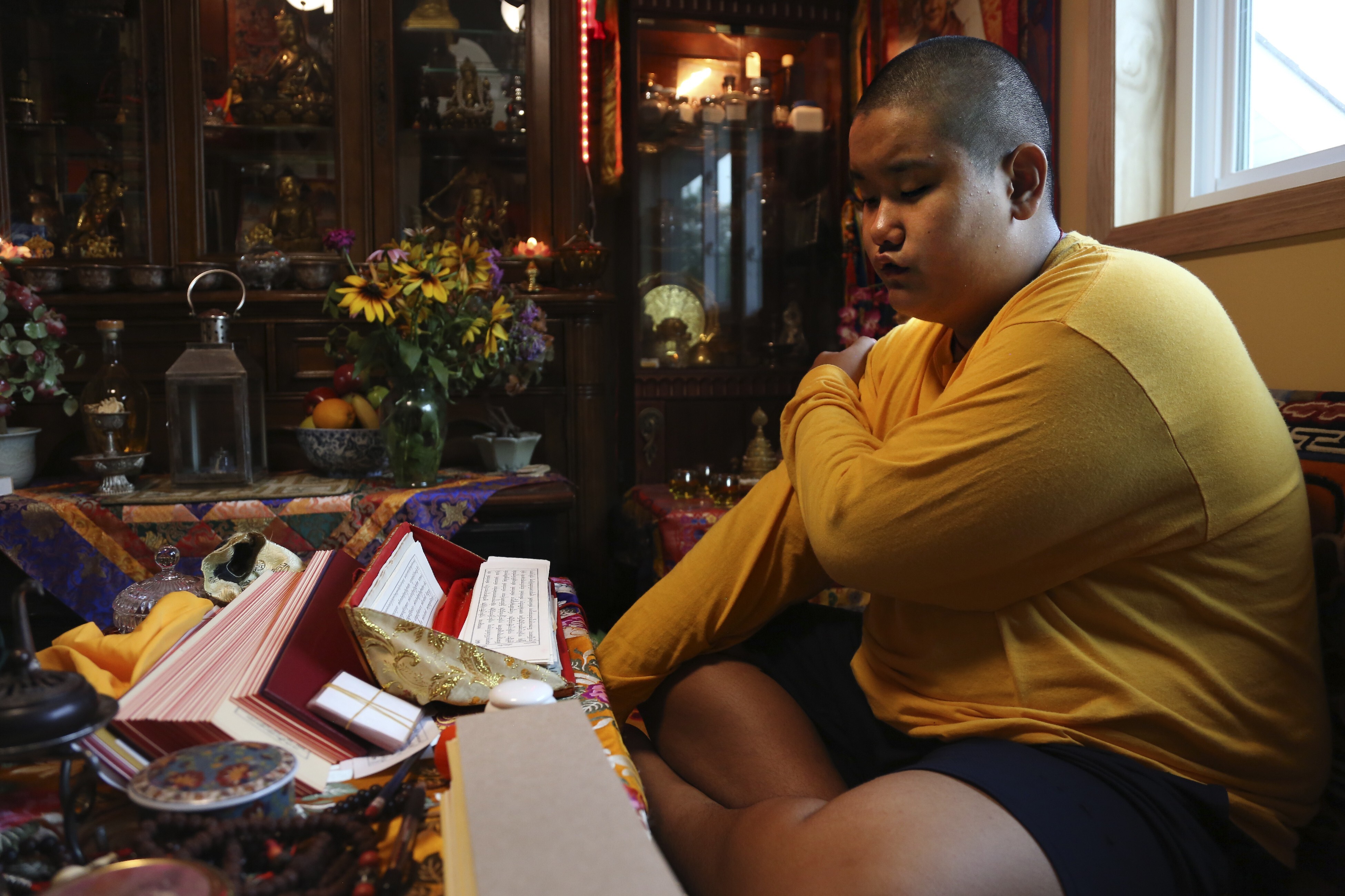 Jalue Dorje, 14, says his morning prayers in Columbia Heights. Photo: AP