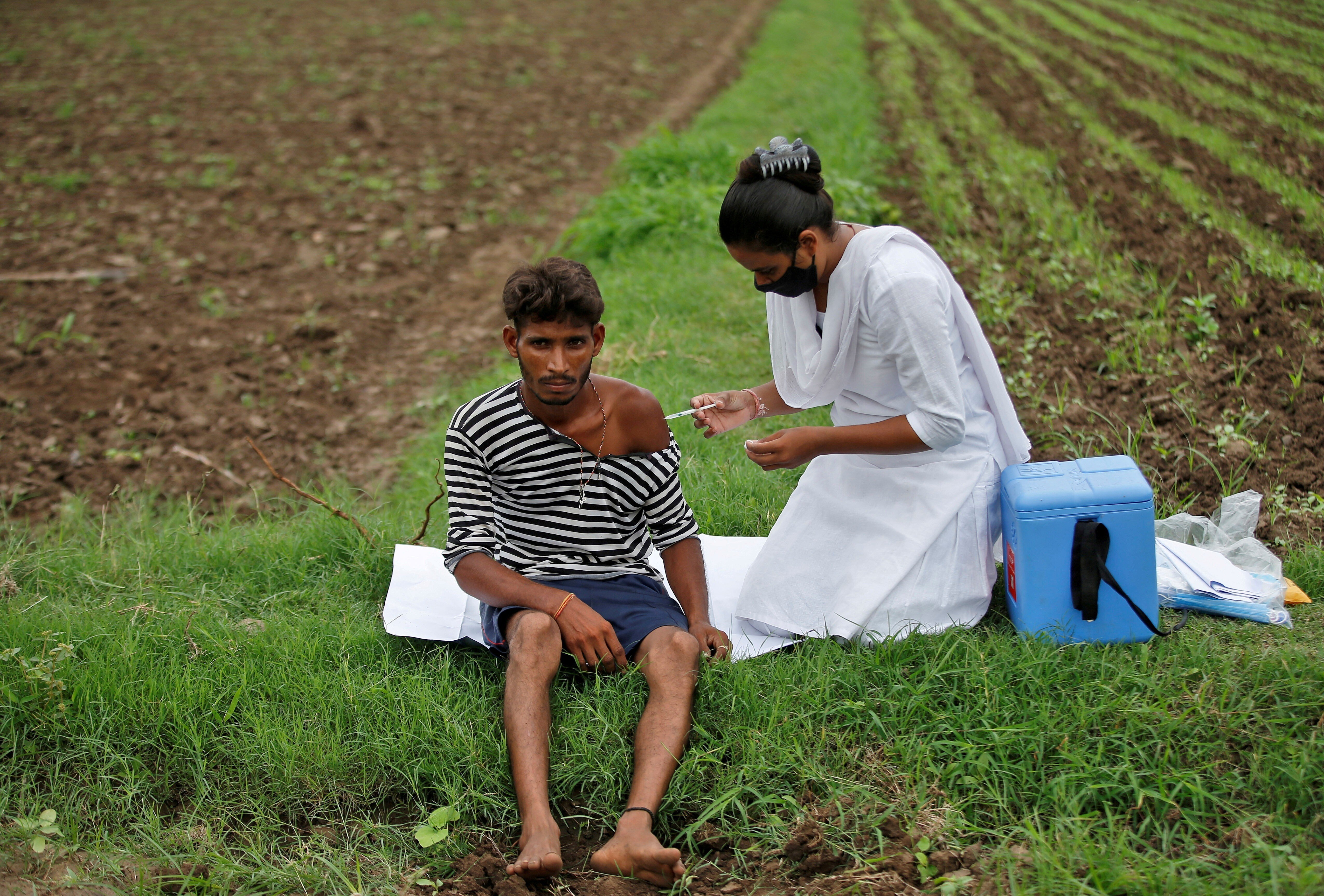 A health worker administers a Covid-19 vaccine dose to a farmer in Gujarat. Photo: Reuters
