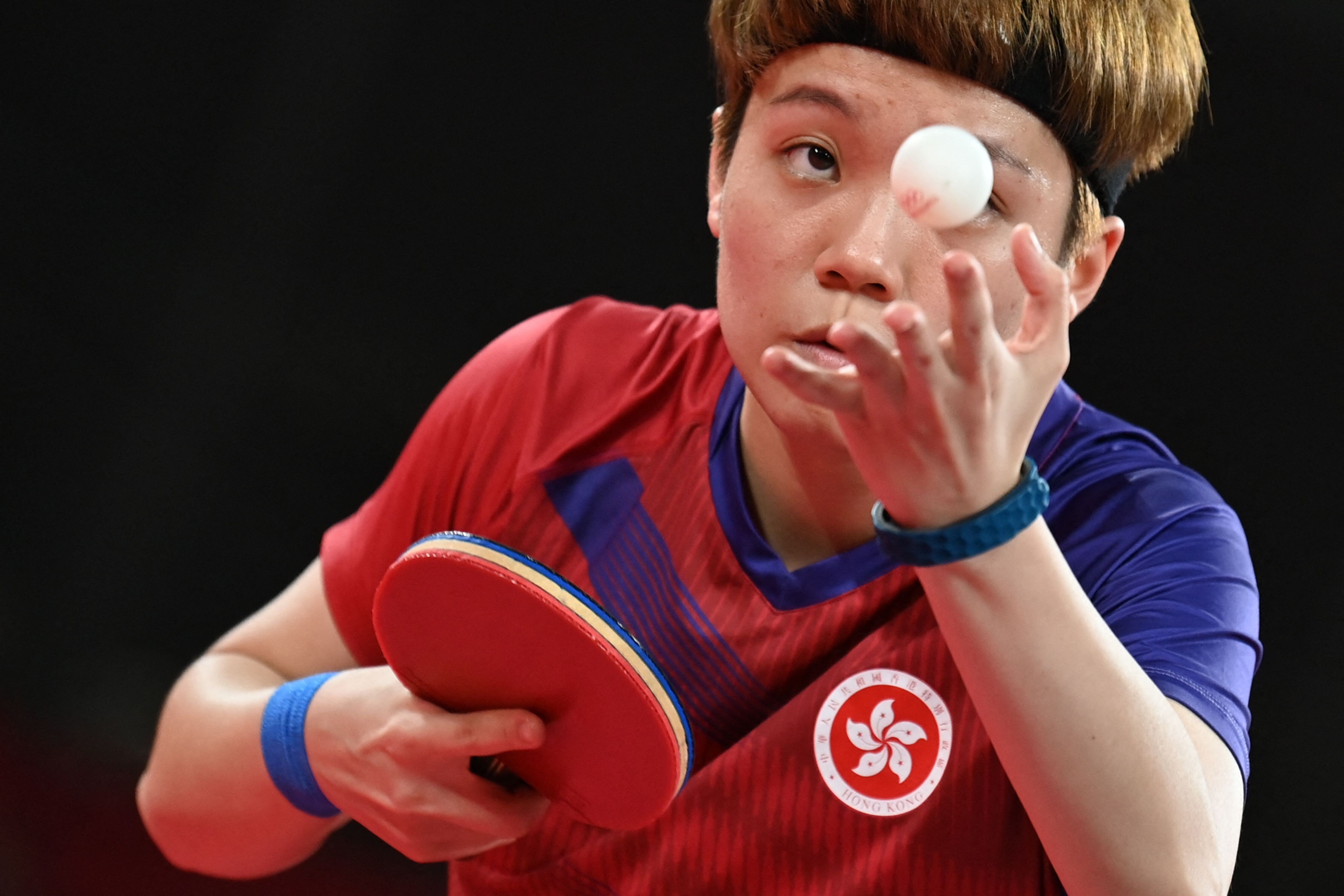 Hong Kong’s Doo Hoi-kem serves to Romania's Bernadette Szocs during their women’s table tennis team quarter-final at the Tokyo 2020 Olympic Games. Photo: AFP