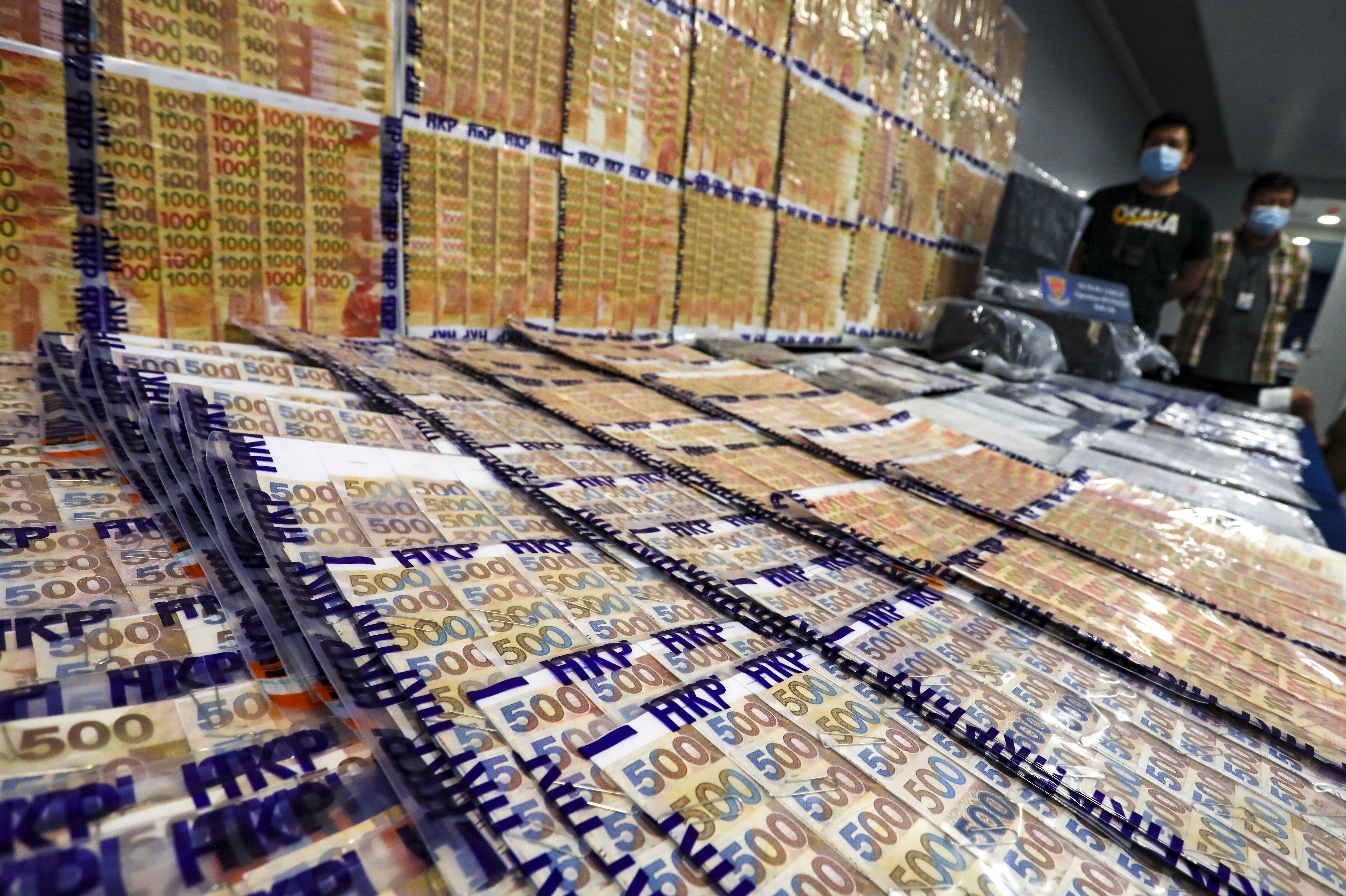 Police display more than HK$10 million in cash seized in a raid on a bookmaking syndicate in July. Photo: Jonathan Wong