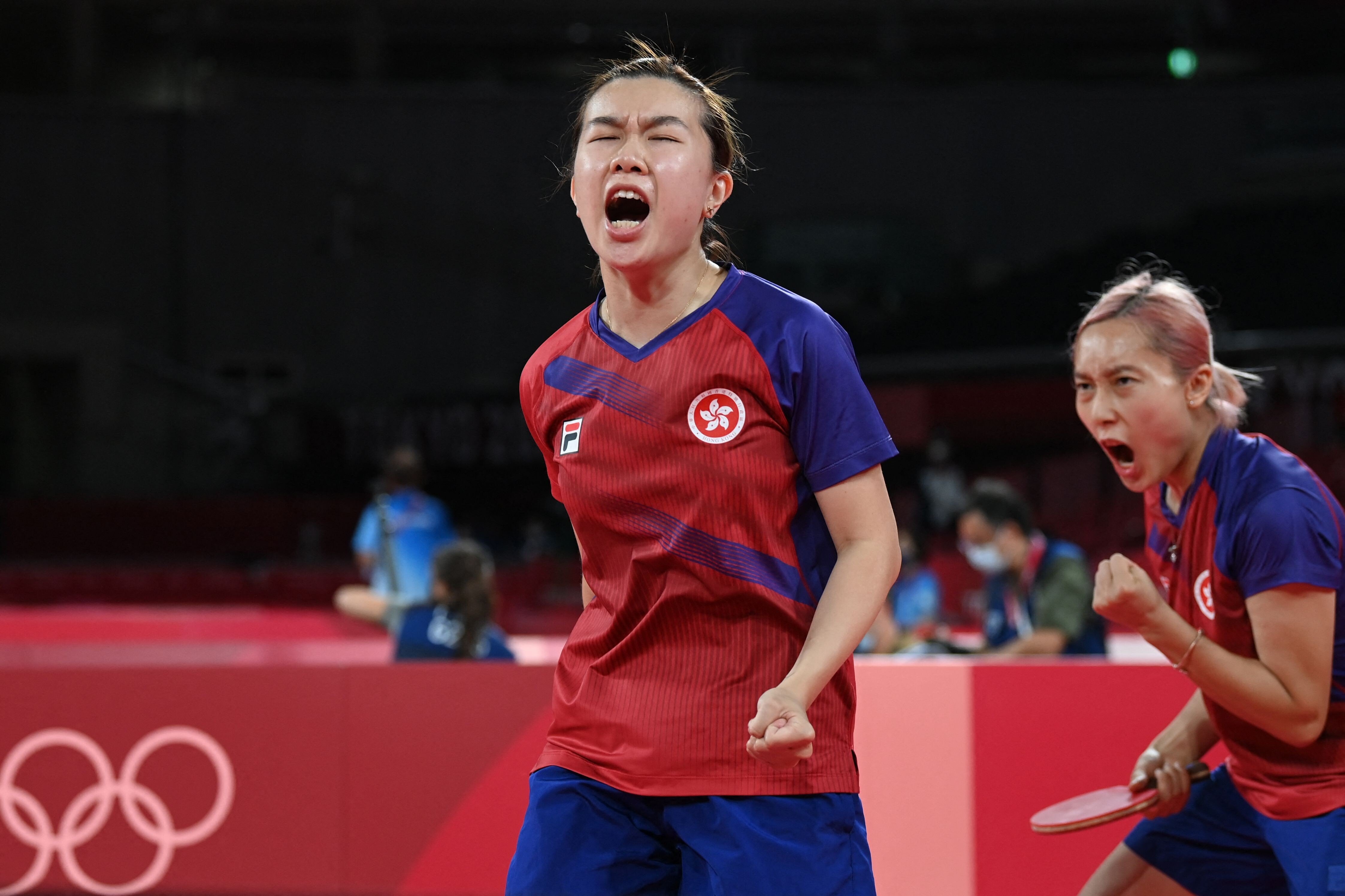 Hong Kong’s Lee Ho-ching and Minnie Soo Wai-yam celebrate winning a point during their women’s team quarter-finals table tennis match against Romania at the Tokyo Olympics. Photo: AFP