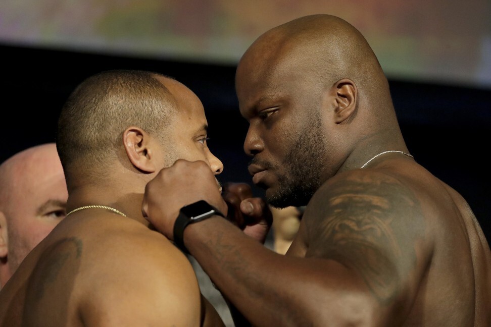 Derrick Lewis (right) poses with Daniel Cormier ahead of their heavyweight title fight at UFC 230. Photo: AP