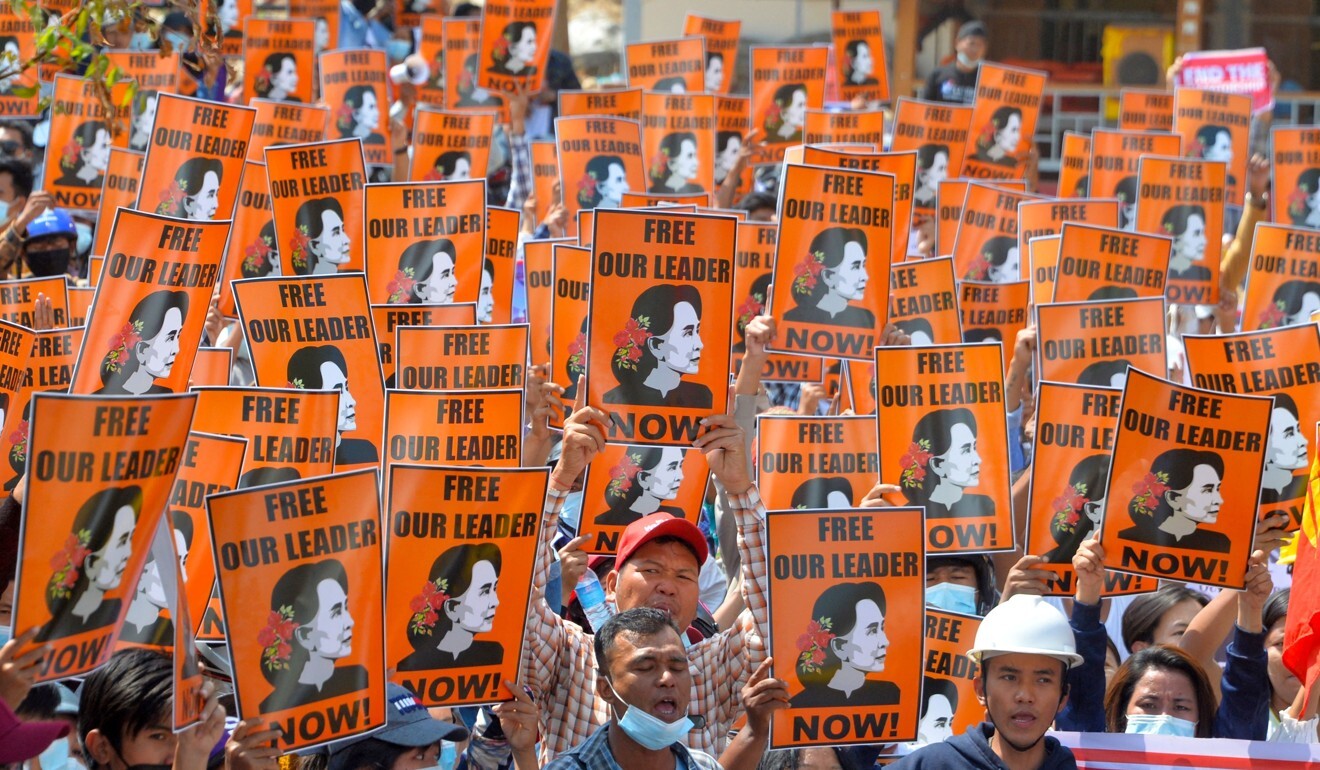Protesters hold posters of detained civilian leader Aung San Suu Kyi during a demonstration against the military coup in Naypyidaw, Myanmar. Photo: AFP