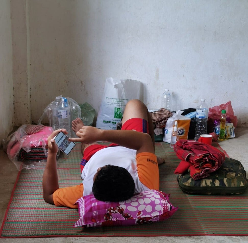 A Cambodian man on a mat at the quarantine centre in Banteay Meanchey province. Photo: Chan Borey