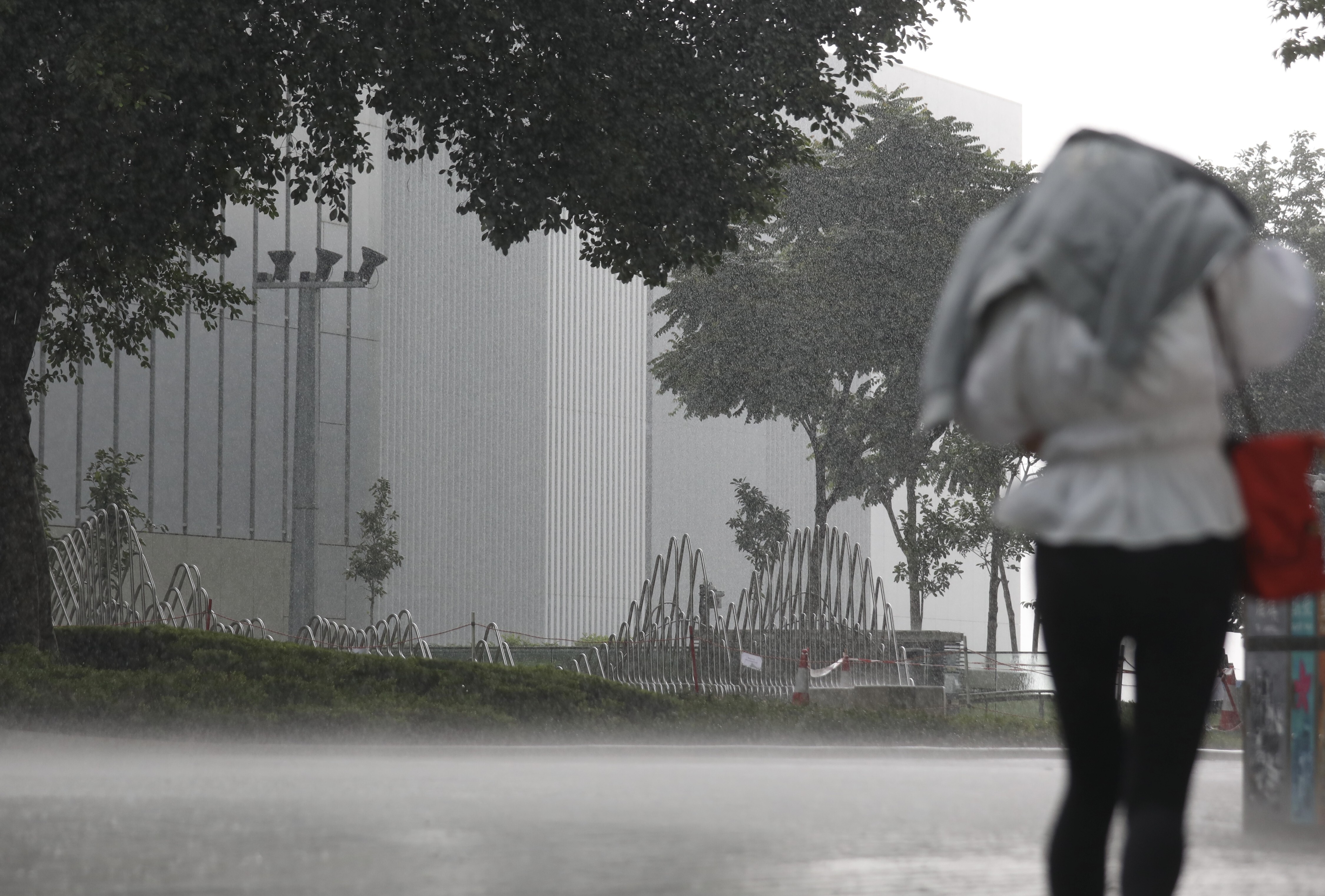 A person walks through Admiralty during a downpour on Wednesday. Photo: Xiaomei Chen