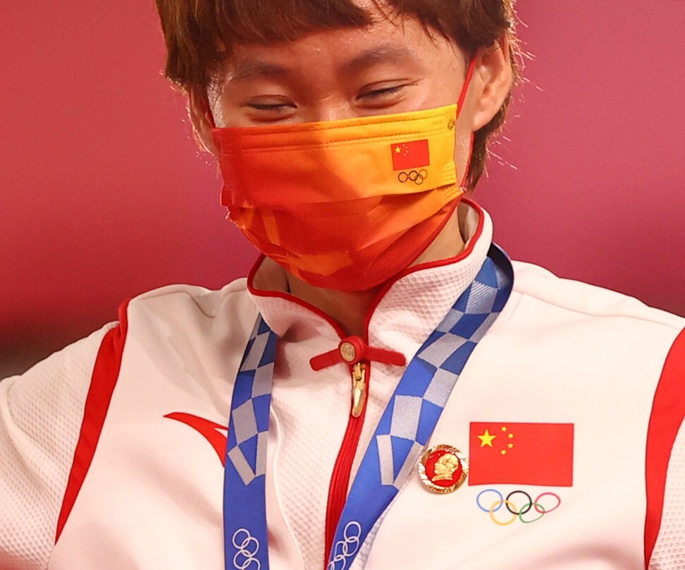 China sprint cyclist Zhong Tianshi wears a Mao Zedong pin during the medal ceremony. Photo: Reuters