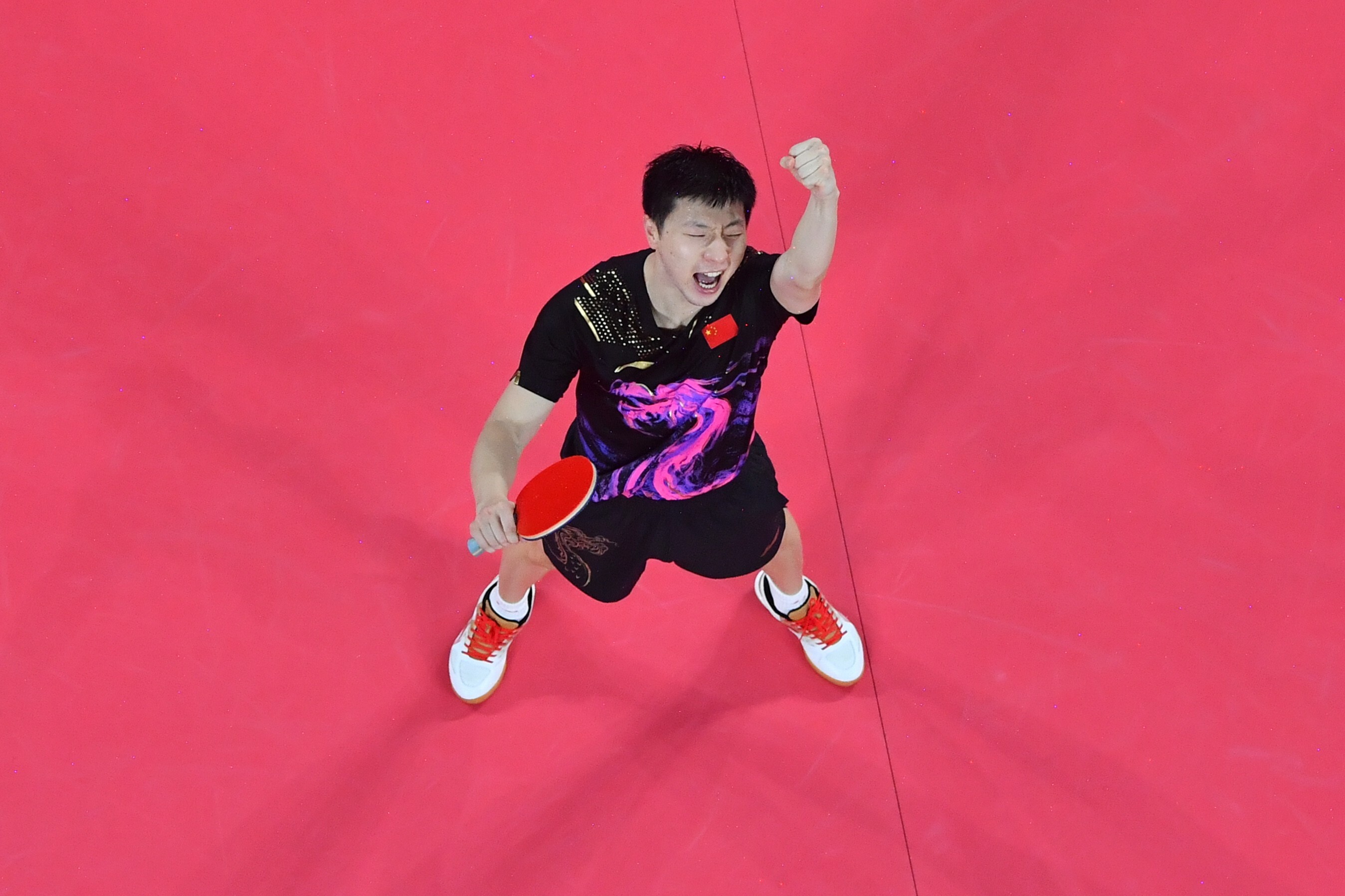 China’s Ma Long celebrates after beating Germany’s Timo Boll for gold in the table tennis men’s team final between at the Tokyo 2020 Olympic Games. Photo: Xinhua