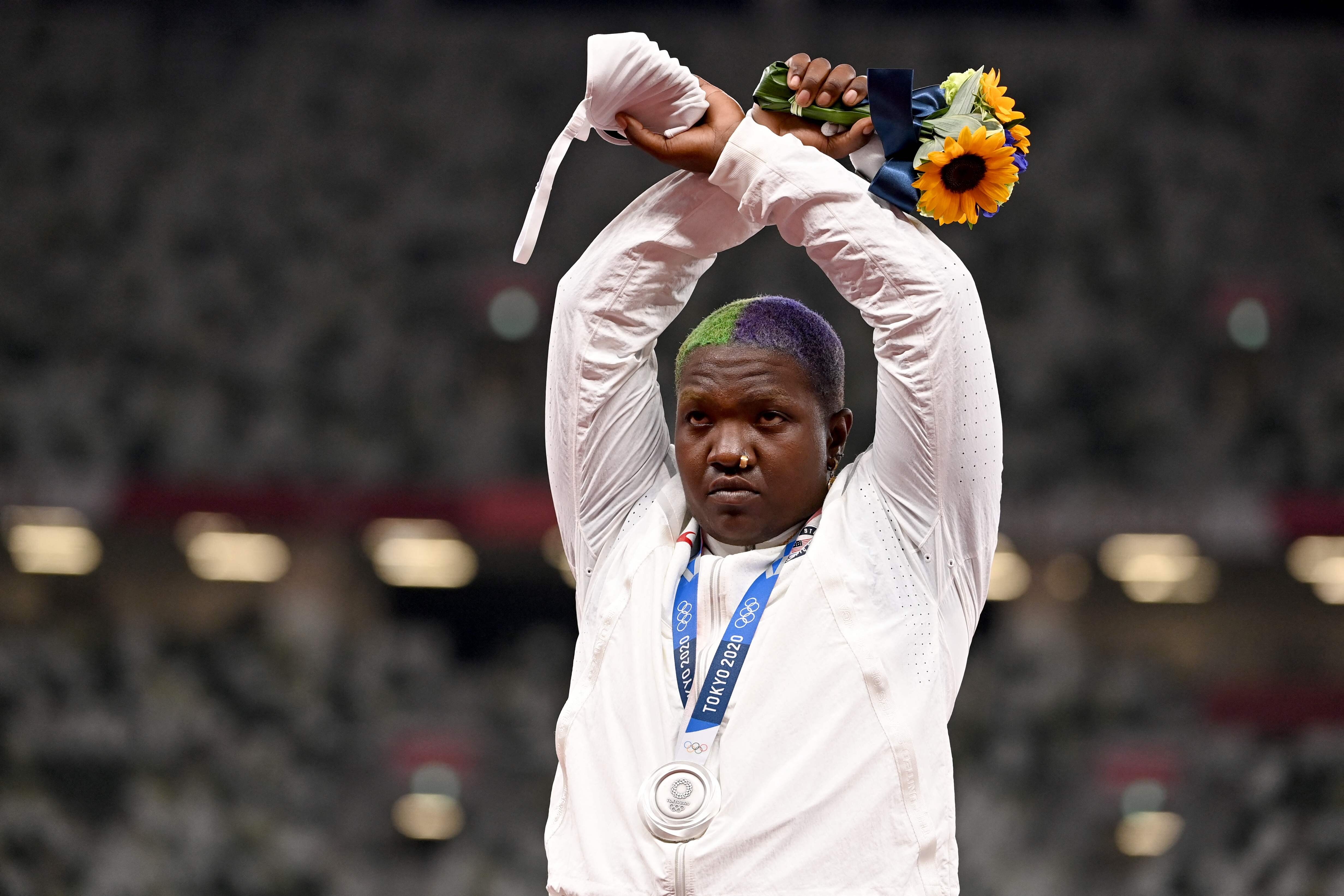 American silver medallist Raven Saunders makes an X sign with her arms while on the podium. Photo: AFP