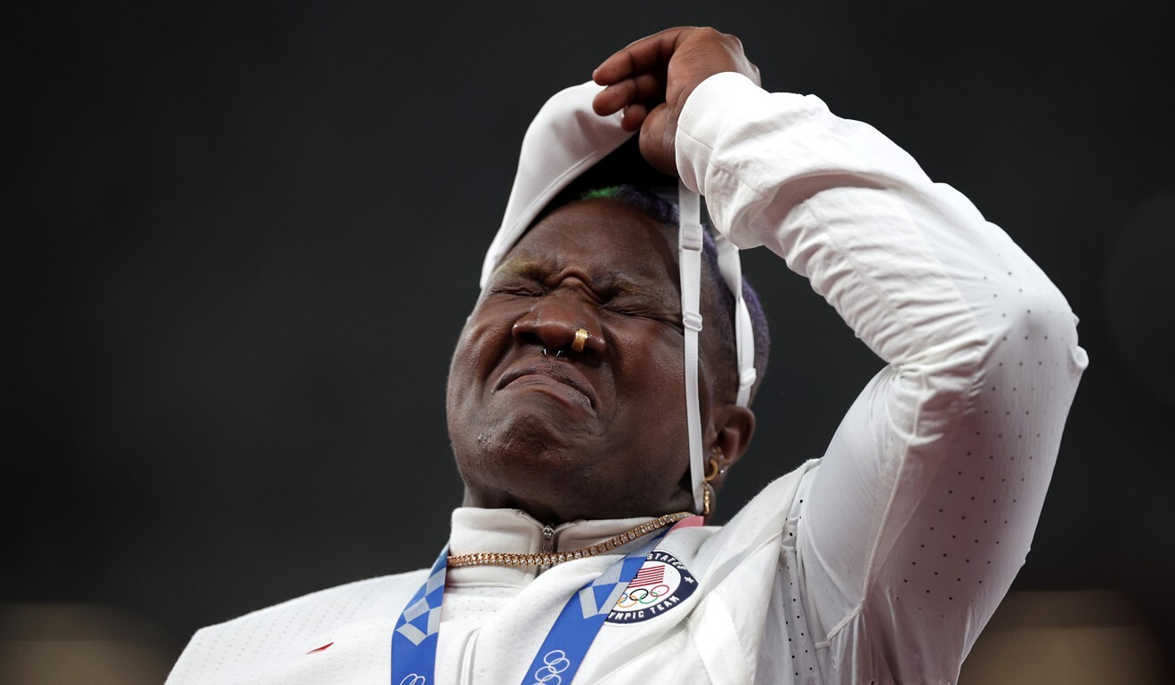 Shot putter Raven Saunders, of the United States, removes her mask as she steps on the podium. Photo: Reuters