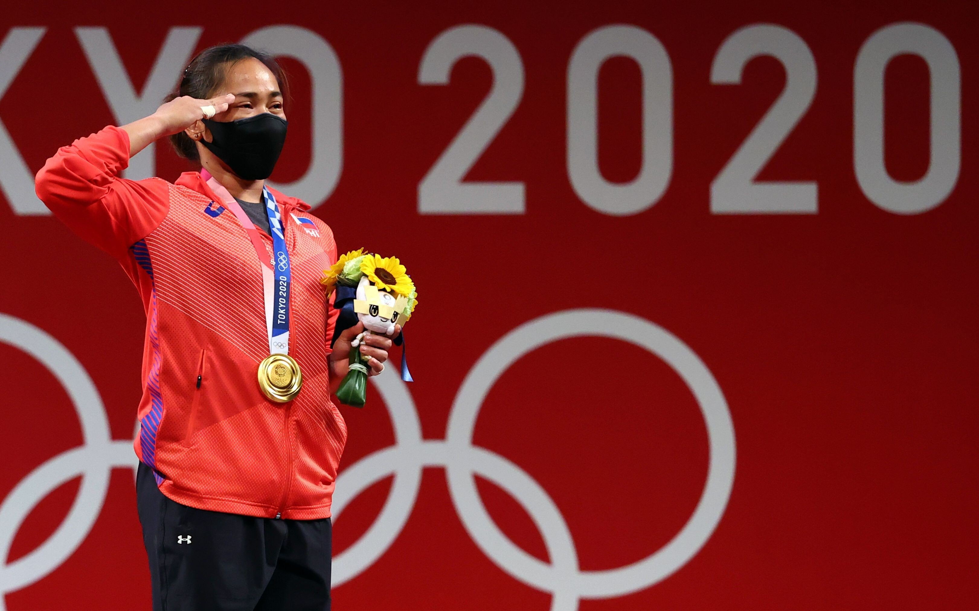 Gold medallist Hidilyn Diaz of the Philippines salutes on the podium at the Tokyo Olympics, after winning the country’s first gold medal. Photo: Reuters