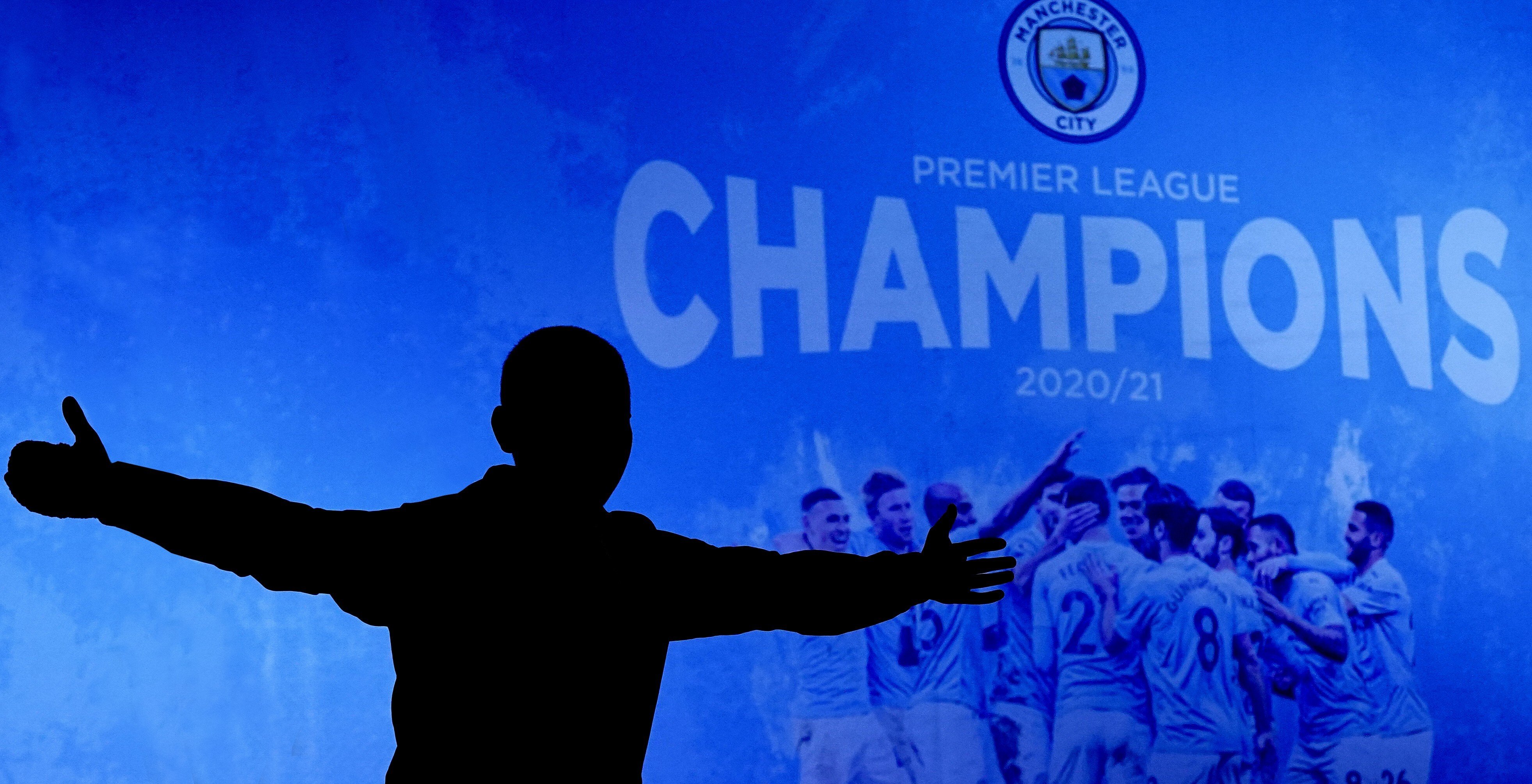 A Manchester City supporter celebrates outside the Etihad Stadium in Manchester after his team clinched the English Premier League title. Photo: AP