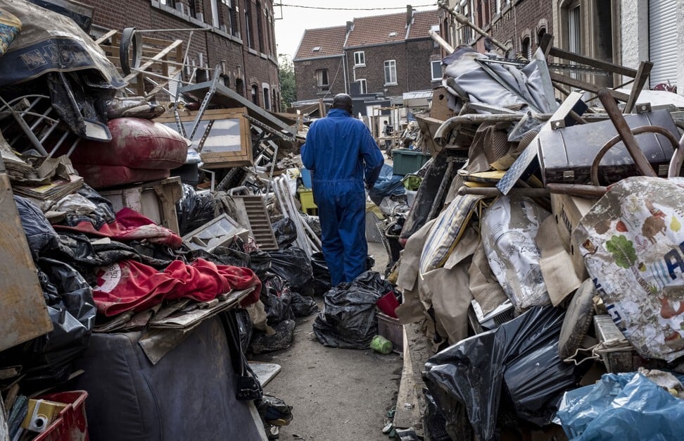 A man walks through piles of rubble in the aftermath of flooding in Belgium’s Liege on July 19, 2021, after severe flooding in Germany and Belgium turned streams and streets into raging torrents that swept away cars and crashed into houses. Photo: AP