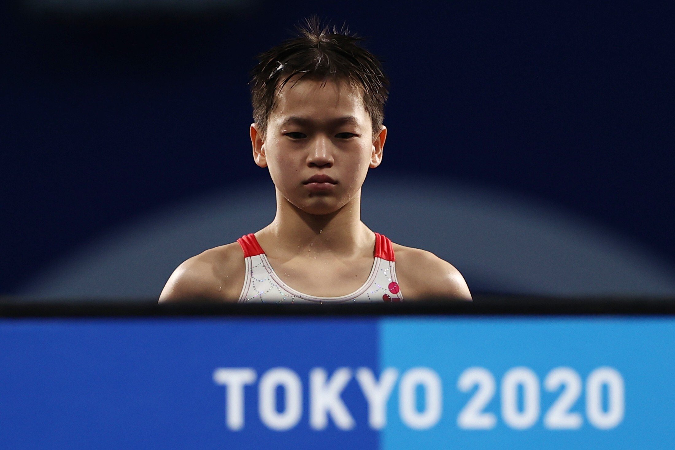 Chinese diver Quan Hongchan looks on from the 10m platform ahead of a dive at the Tokyo 2020 Olympic Games. Photo: Reuters