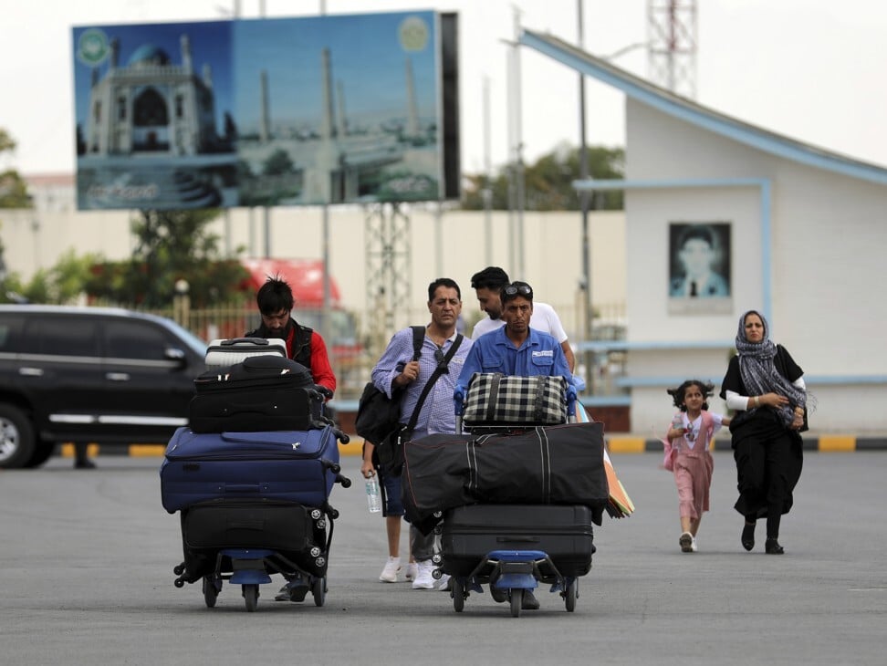 Passengers walk to the departures terminal of Hamid Karzai International Airport in Kabul, Afghanistan, on August 14, 2021. Photo: AP