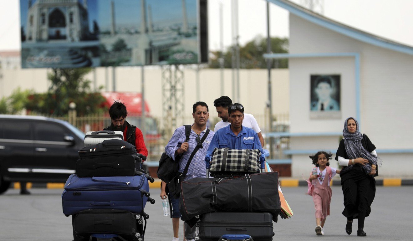 Passengers walk to the departures terminal of the airport in Kabul. Photo: AP