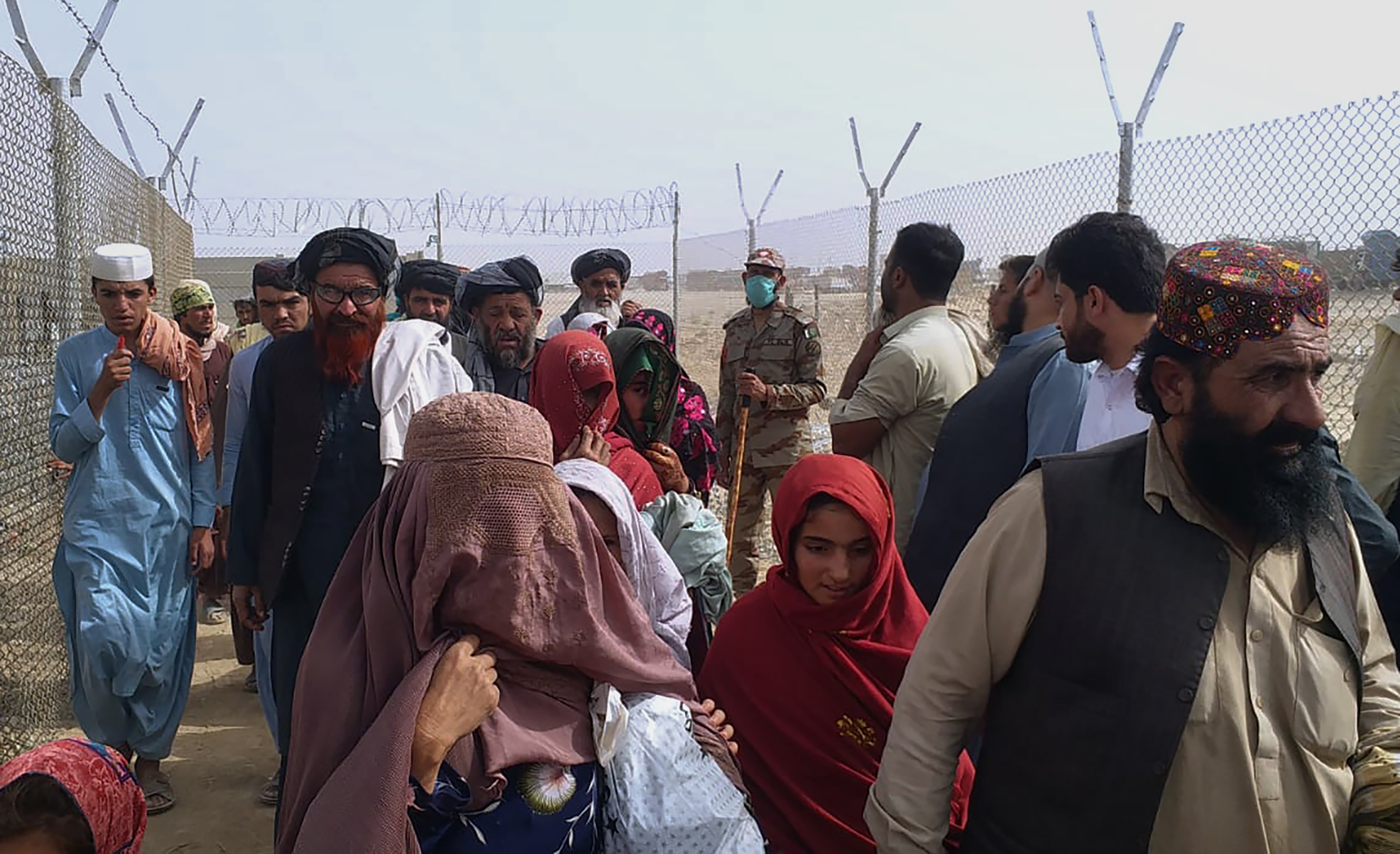 People cross the border from Afghanistan into Pakistan to flee the Taliban’s advance. Photo: AP