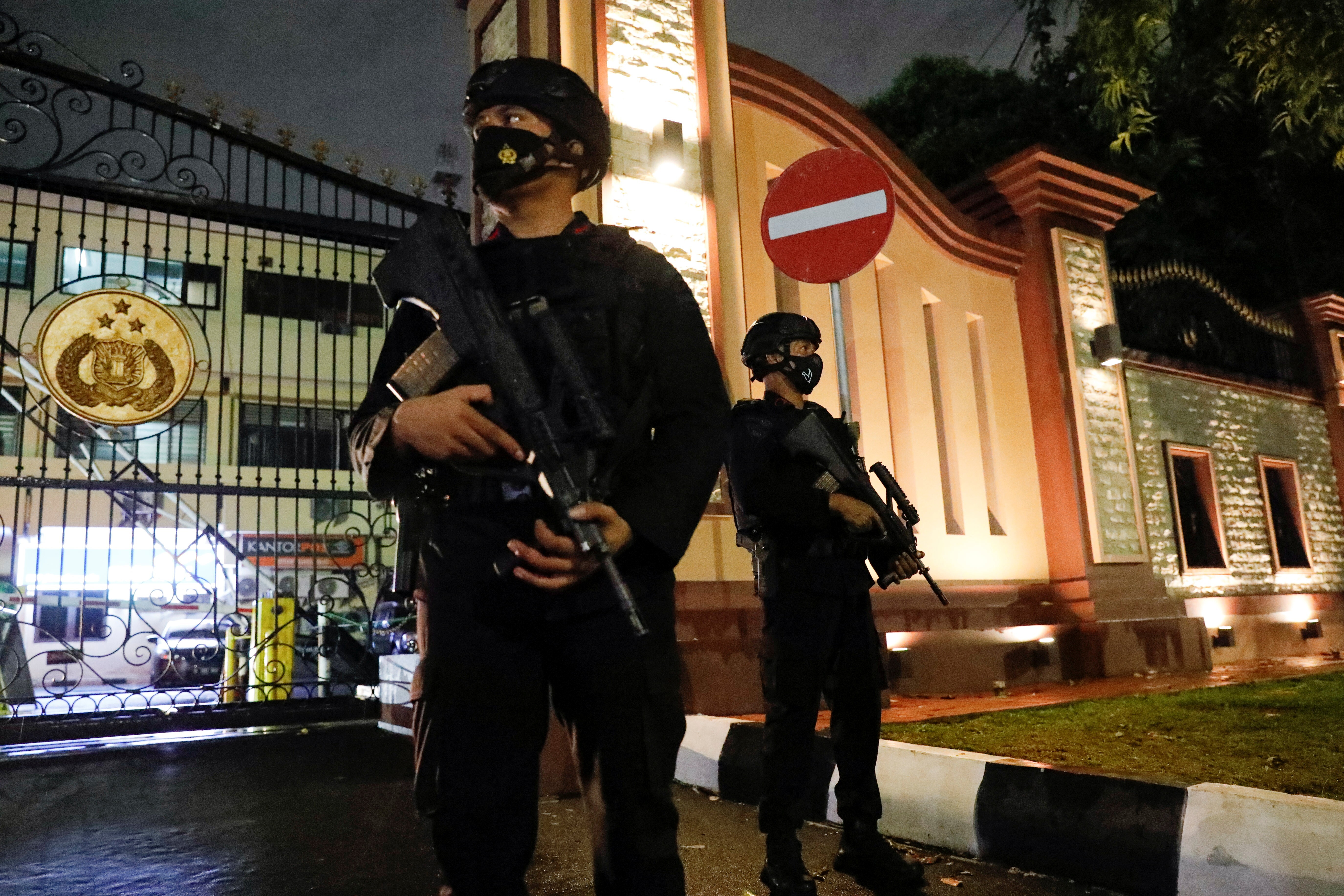 Armed police officers stand guard at the gate of national police headquarters in Jakarta following a militant attack. Photo: Reuters