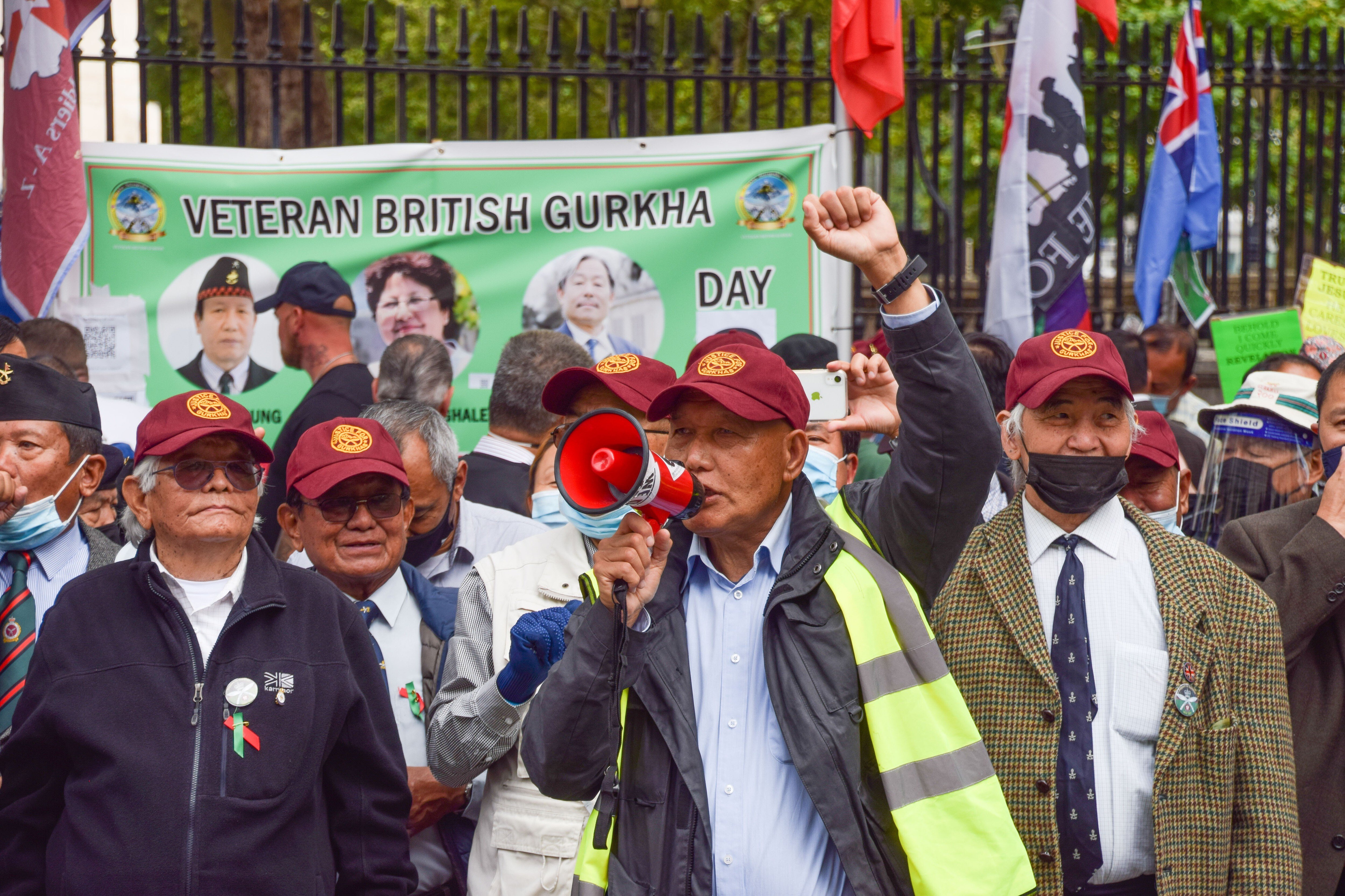 A Gurkha veteran speaks through a megaphone during a protest outside 10 Downing Street. Photo: Handout