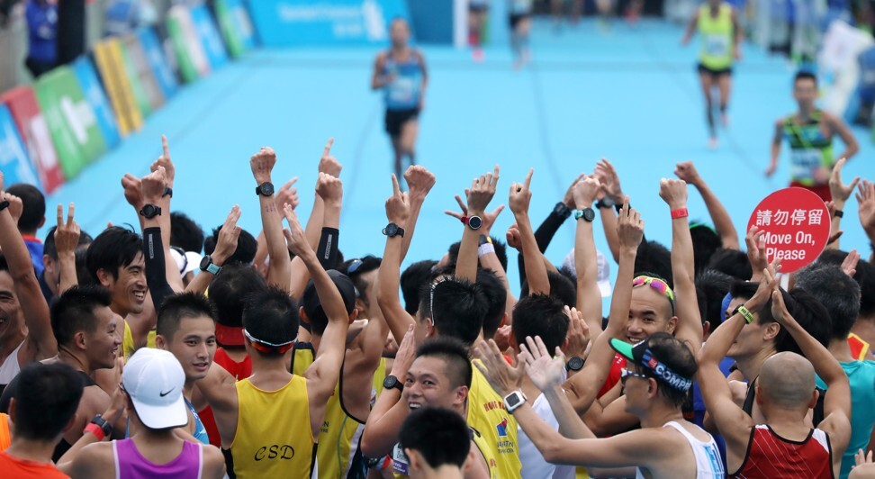 Participants gather at the finish line in Victoria Park after the Standard Chartered Hong Kong Marathon. Photo: SCMP / Nora Tam