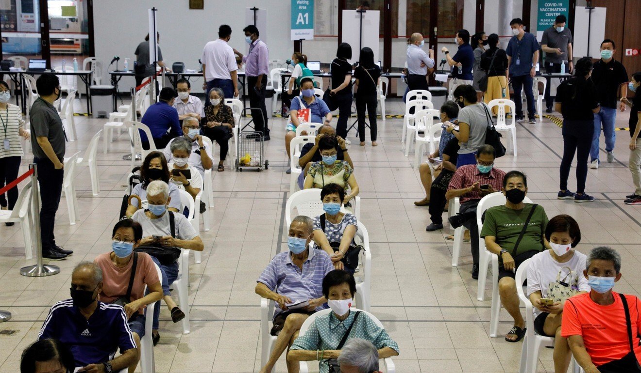 Singaporeans wait in an observation area after getting a vaccine dose. Photo: Reuters